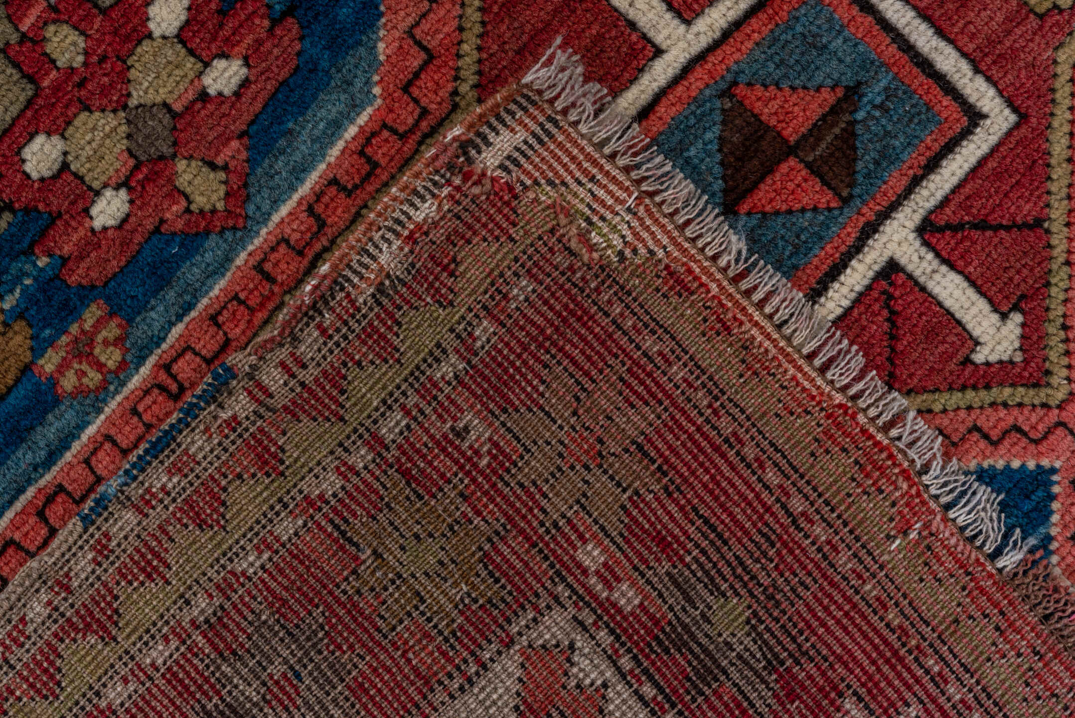 3' x 8' one-of-a-kind handmade vintage Kazak runner rug. Color palette: red, ivory, brown, blue, charcoal, rust, rose, taupe