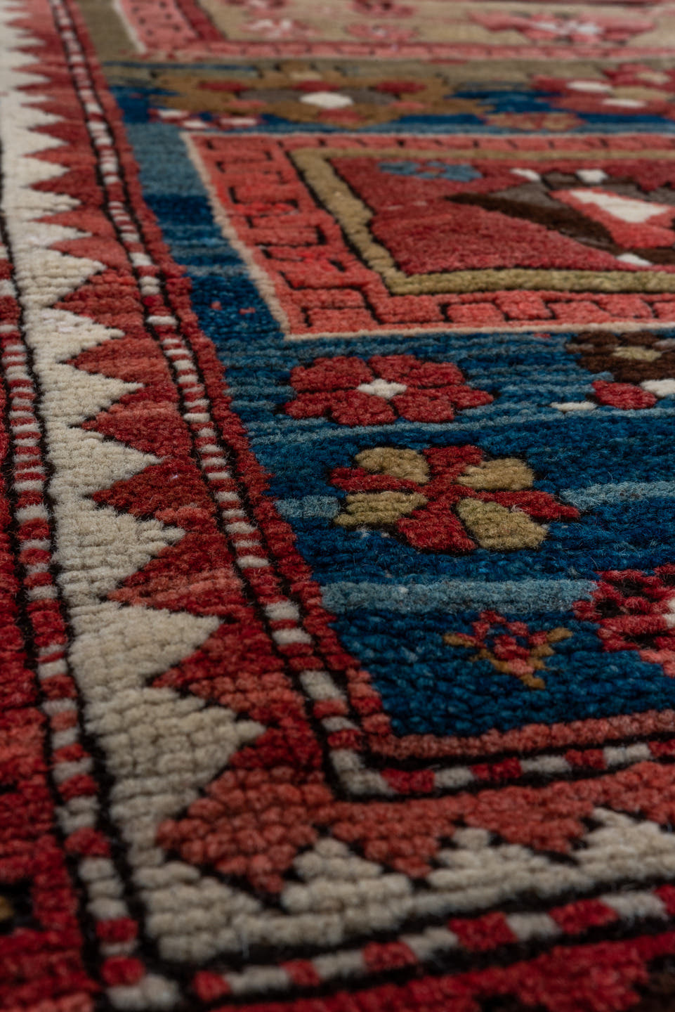 3' x 8' one-of-a-kind handmade vintage Kazak runner rug. Color palette: red, ivory, brown, blue, charcoal, rust, rose, taupe