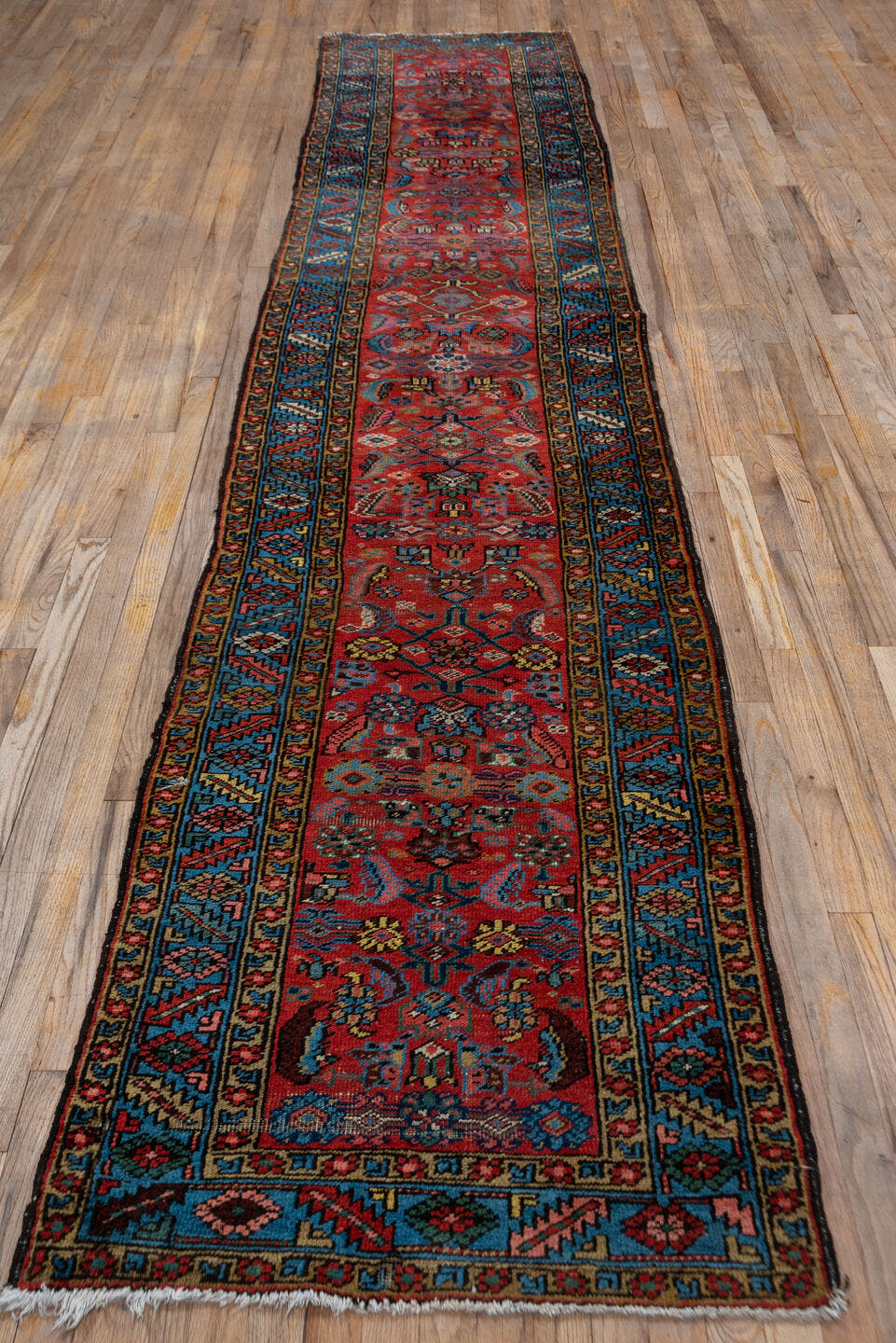2' x 13' one-of-a-kind handmade vintage Heriz runner rug. Color palette: red, blue, navy, ivory, rust, gold, charcoal