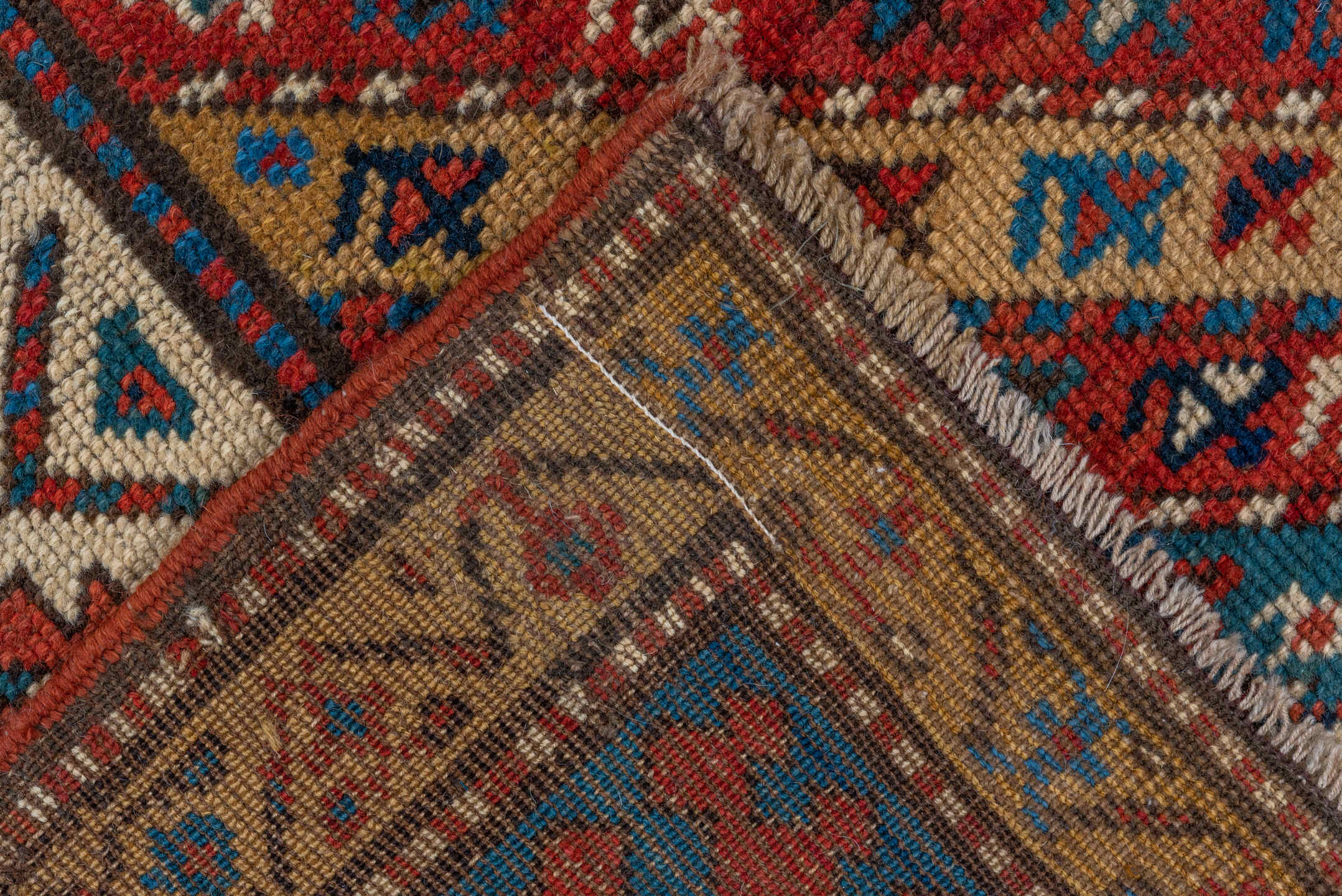 4' x 9' one-of-a-kind handmade antique Kazak runner rug. Color palette: rust, ivory, blue, navy, camel, crimson, charcoal