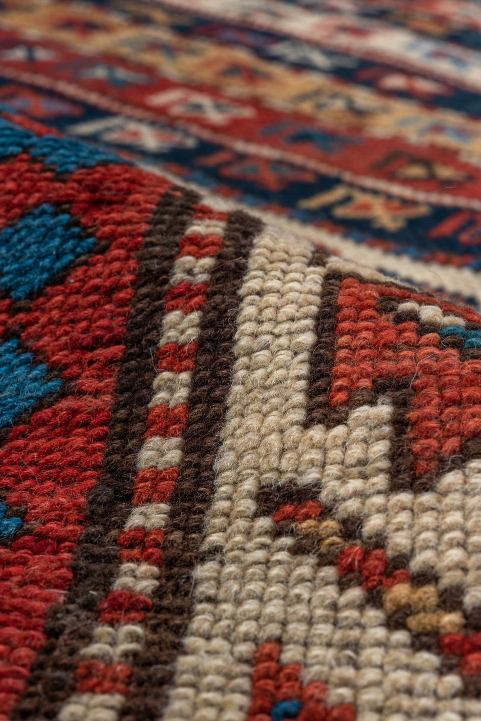 4' x 9' one-of-a-kind handmade antique Kazak runner rug. Color palette: rust, ivory, blue, navy, camel, crimson, charcoal