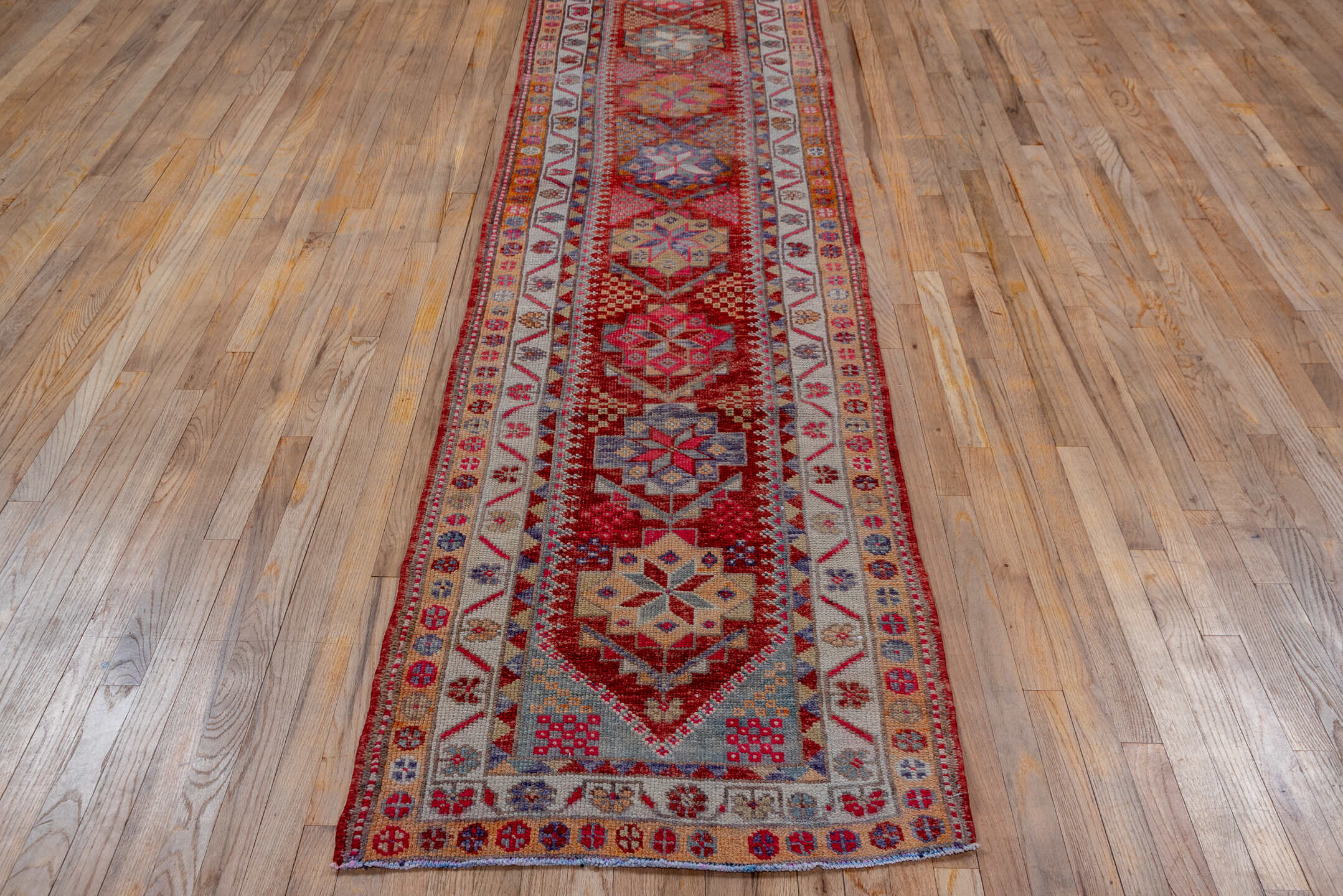 2' x 11' one-of-a-kind handmade vintage Oushak runner rug. Color palette: red, ivory, blue, pink, gold, rust, lavender