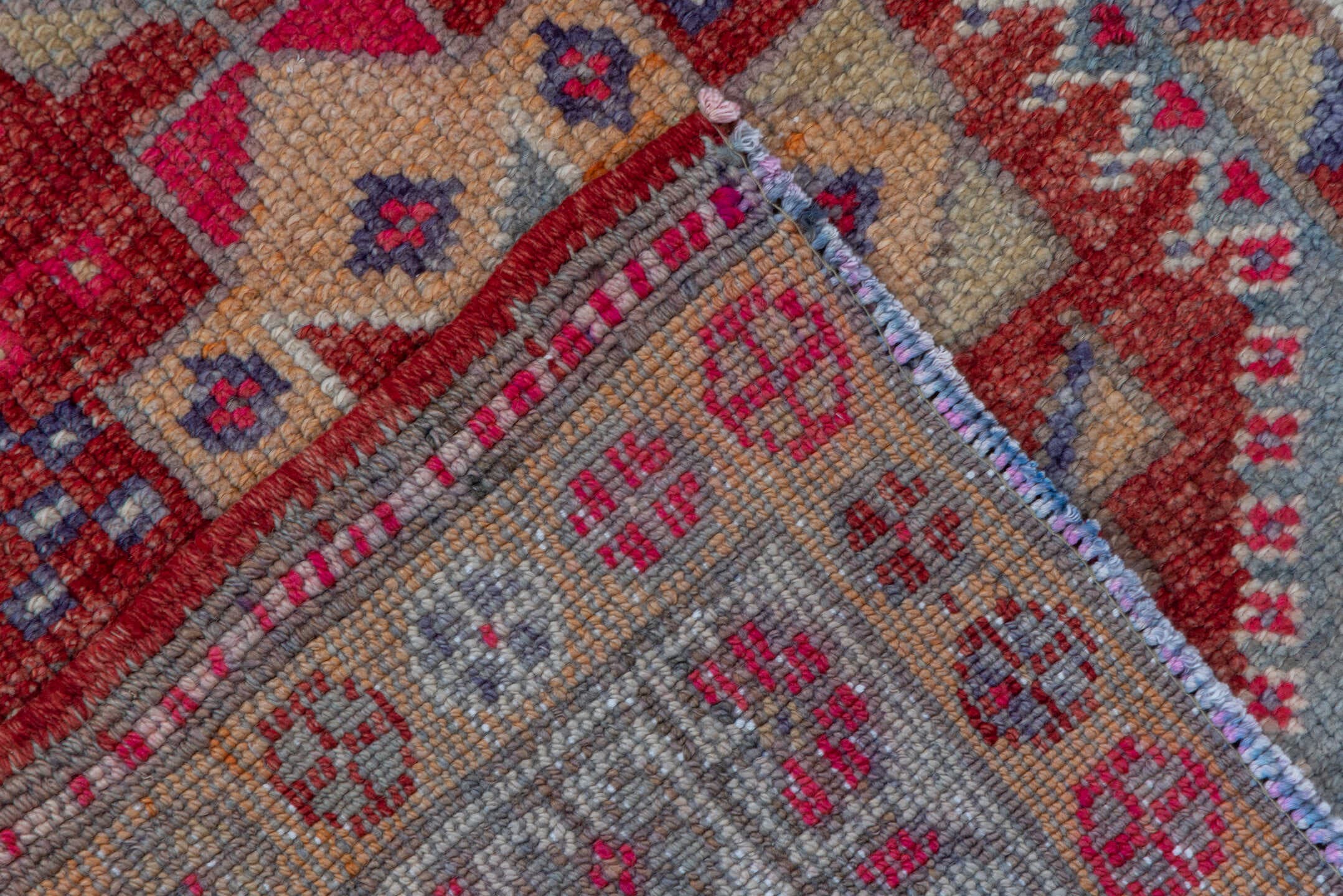 2' x 11' one-of-a-kind handmade vintage Oushak runner rug. Color palette: red, ivory, blue, pink, gold, rust, lavender