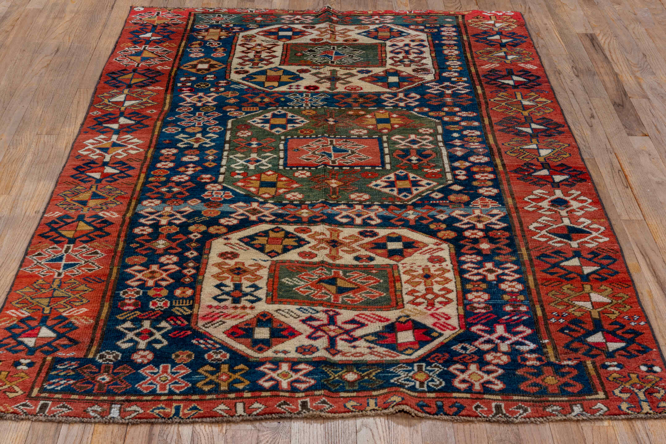 4' x 6' one-of-a-kind handmade vintage Kazak small size rug. Color palette: blue, brown, gray, pink, red