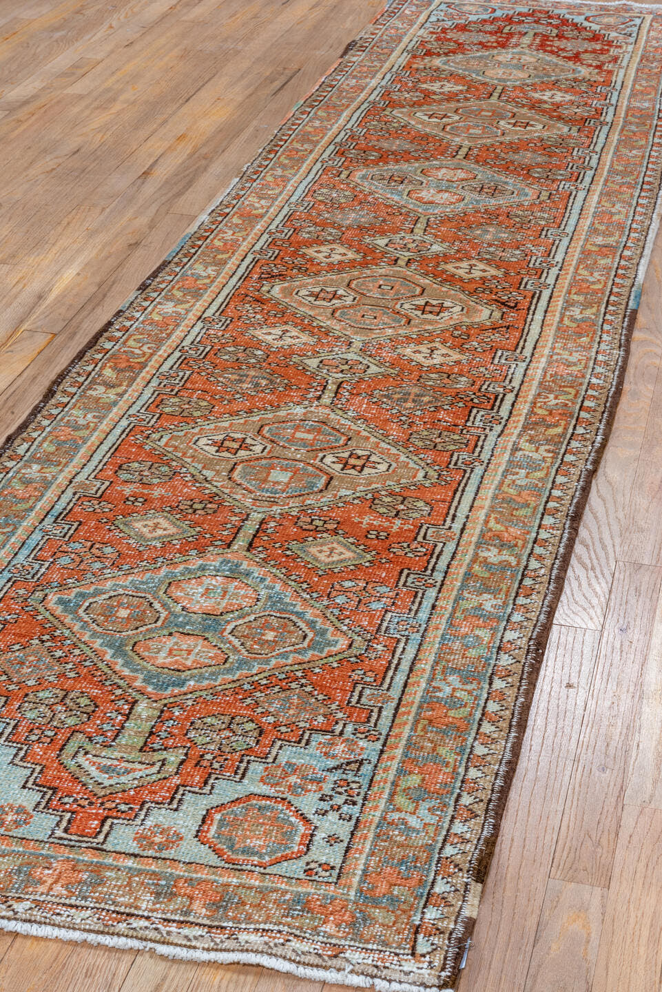 2' x 10' one-of-a-kind handmade vintage Heriz runner rug. Color palette: terra cotta, ivory, pale blue, taupe, rust, sage