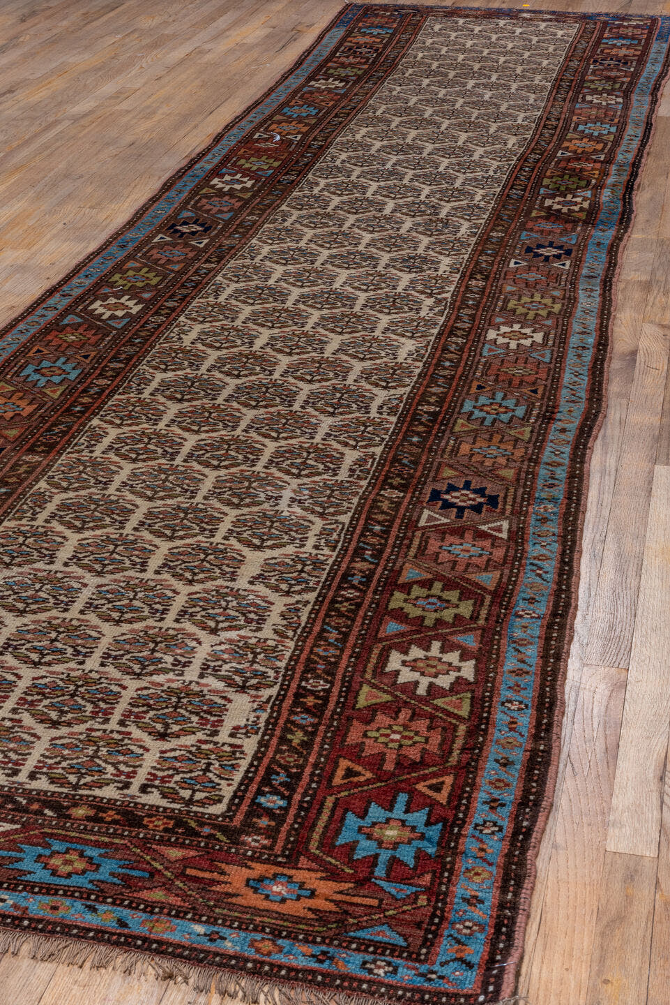 3' x 16' one-of-a-kind handmade vintage Kurd runner rug. Color palette: ivory, rust, brown, sky_blue, indigo, camel, navy