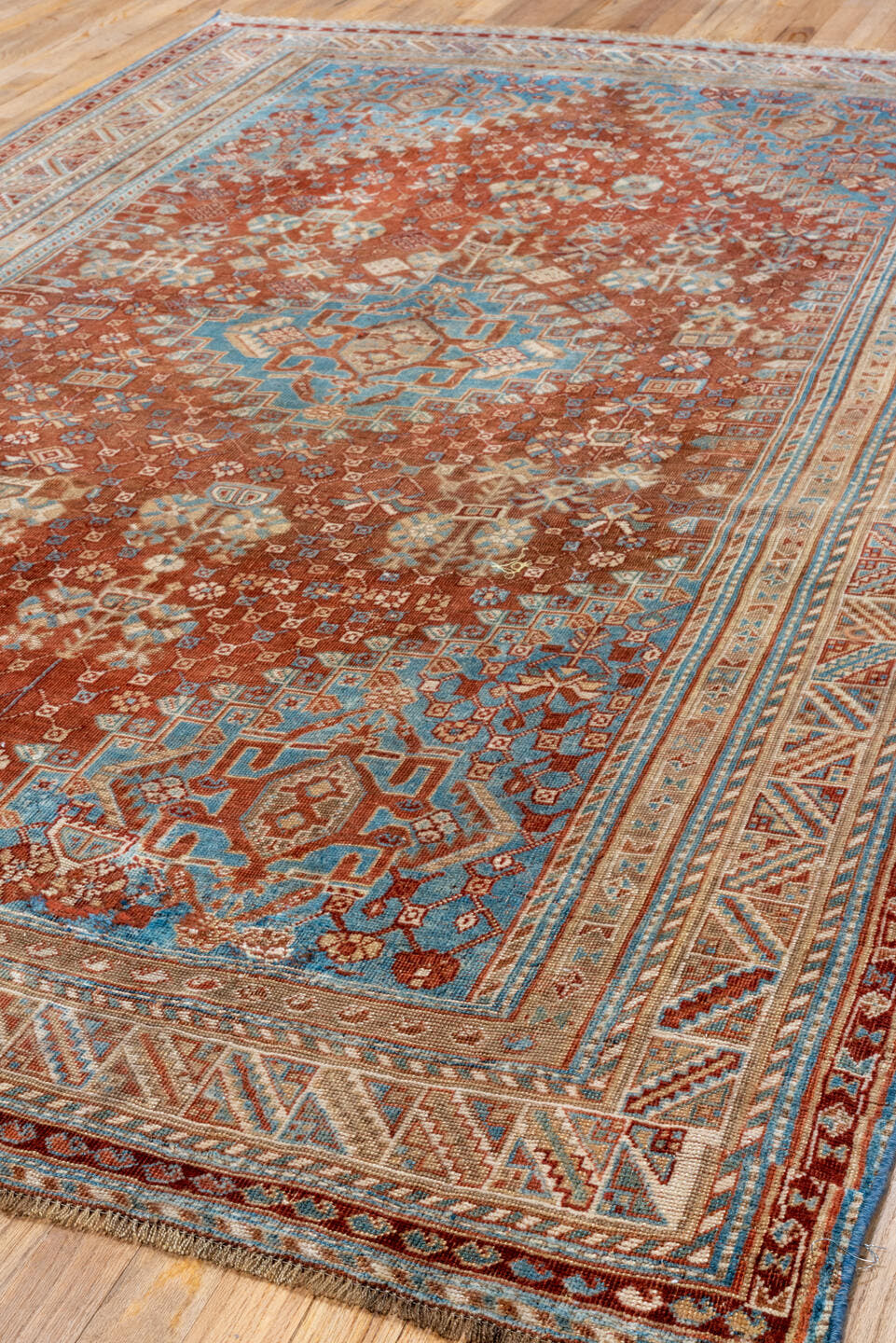 5' x 9' one-of-a-kind handmade vintage Qashqai medium size rug. Color palette: rust, sky blue, ivory, camel, taupe
