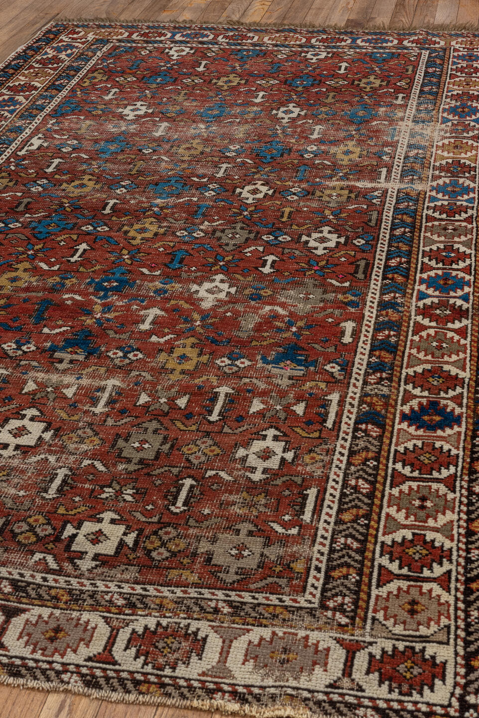 4' x 7' one-of-a-kind handmade vintage Shirvan rug. Color palette: rust, ivory, blue, camel, brown, charcoal, terracotta