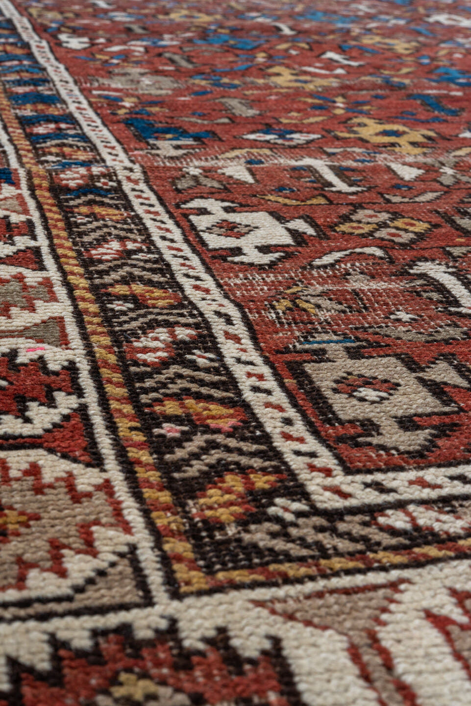 4' x 7' one-of-a-kind handmade vintage Shirvan rug. Color palette: rust, ivory, blue, camel, brown, charcoal, terracotta