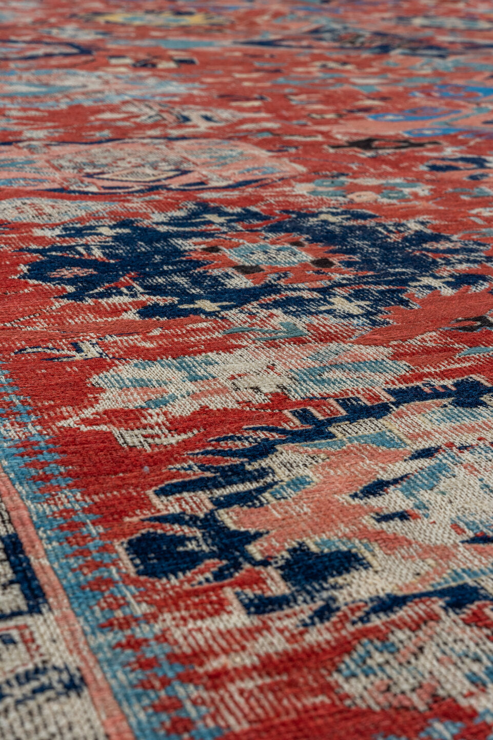 5' x 7' one-of-a-kind handmade vintage Sumak rug. Color palette: black, blue, brown, charcoal, dark gray, gray, pink, red