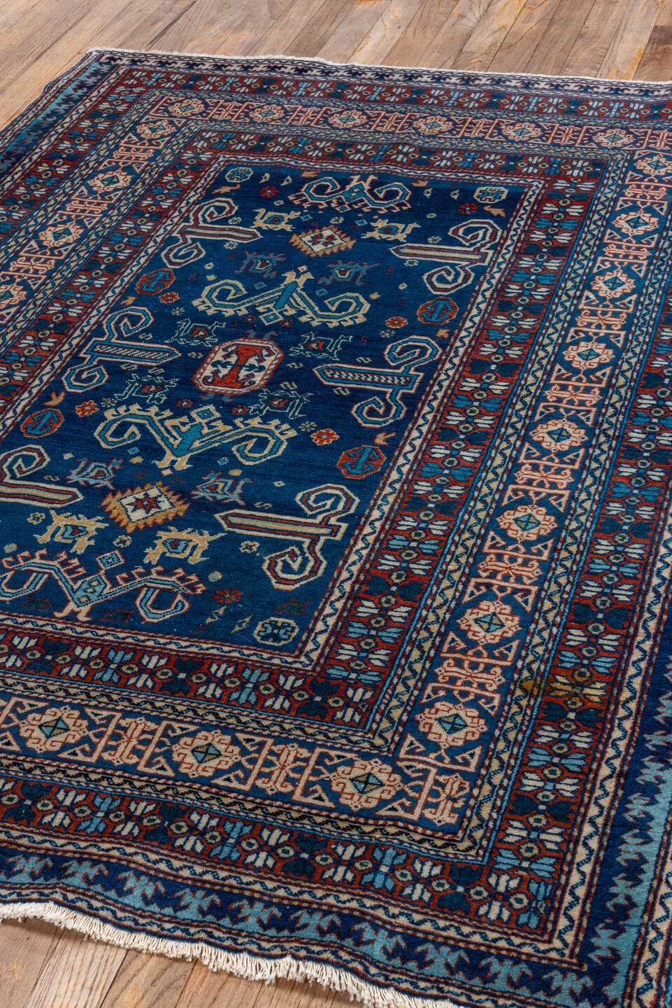 4' x 5' one-of-a-kind handmade vintage Shirvan small size rug. Color palette: navy, ivory, rust, sky_blue, crimson, camel