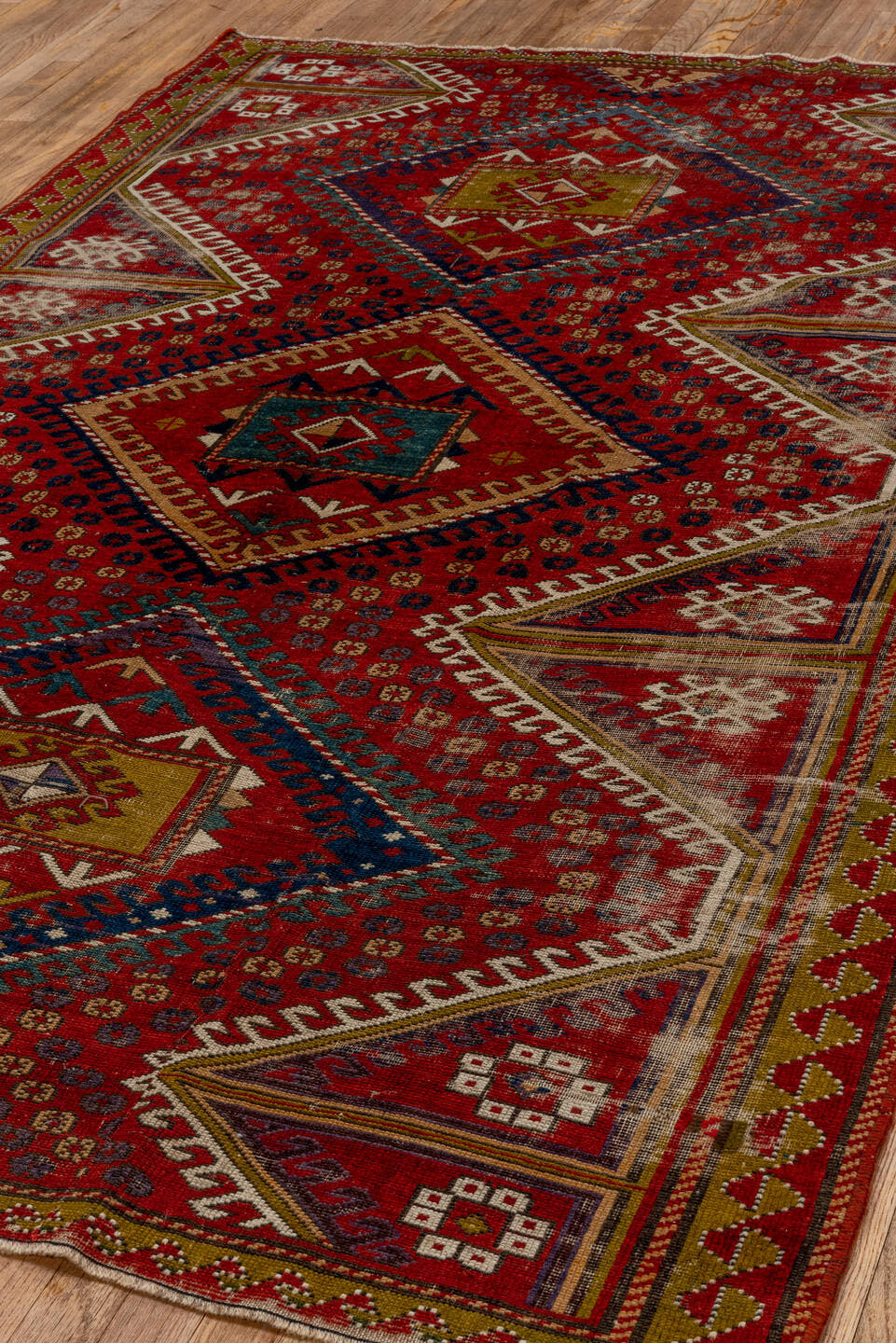 5' x 7' one-of-a-kind handmade vintage Kazak rug. Color palette: red, ivory, navy, olive, gold, rust, sky_blue, brown, blue