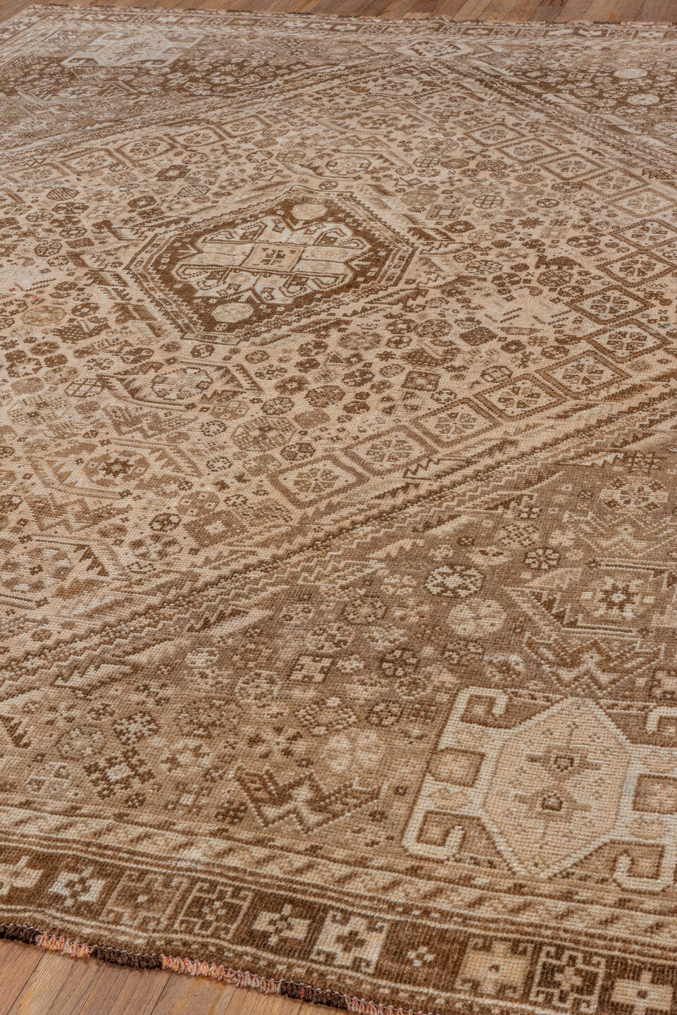 7' x 9' one-of-a-kind handmade vintage Shiraz rug. Color palette: camel, ivory, taupe, brown, sand, beige, gray