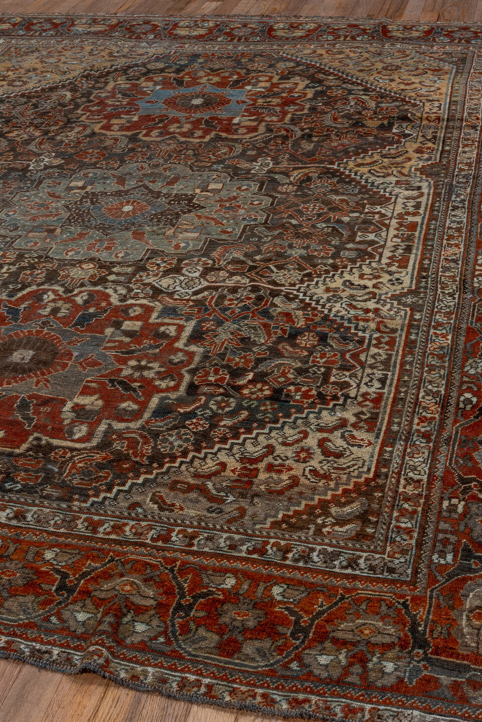 7' x 9' one-of-a-kind handmade vintage Shiraz rug. Color palette: rust, ivory, charcoal, slate, terracotta, brown, sky_blue