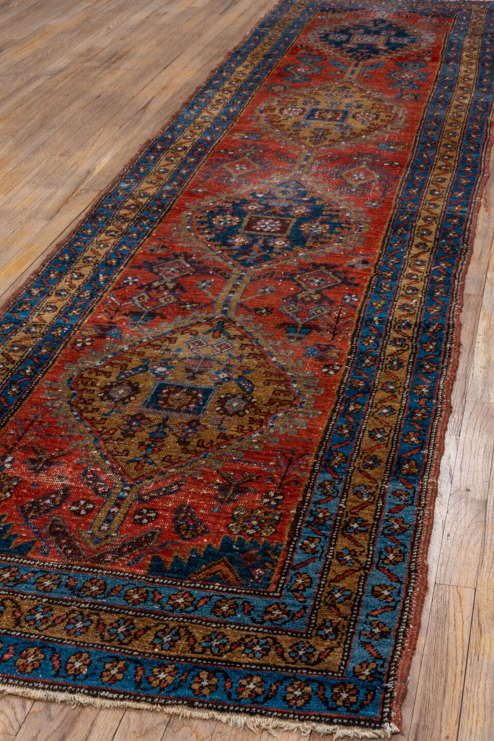 3' x 13' one-of-a-kind handmade vintage Heriz runner rug. Color palette: rust, navy, sky blue, camel, ivory, terracotta