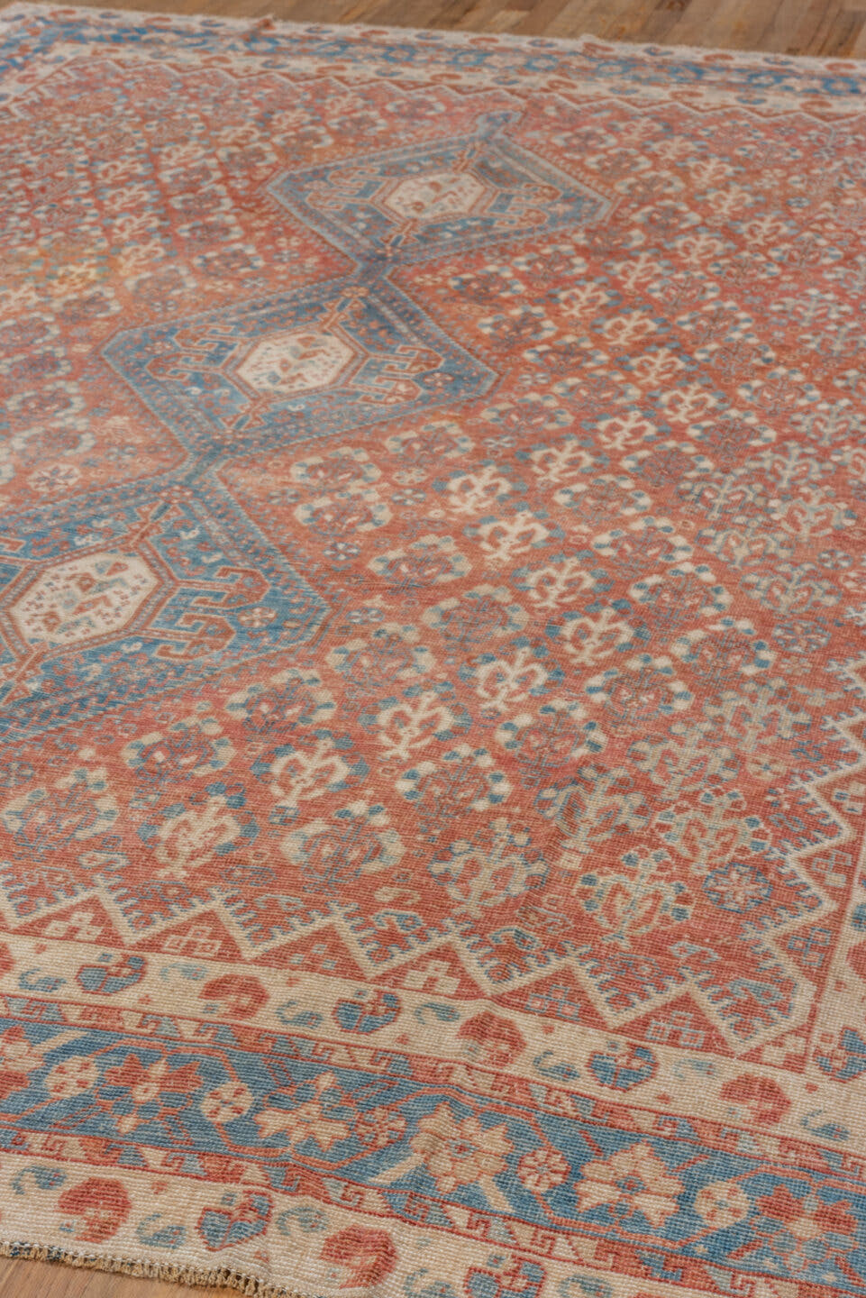 7' x 9' one-of-a-kind handmade vintage Shiraz rug. Color palette: terra cotta, ivory, sky blue, rust, beige, slate
