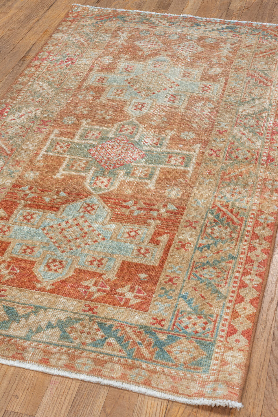 3' x 5' one-of-a-kind handmade vintage Heriz small size rug. Color palette: terra cotta, ivory, pale blue, rust, camel, sage