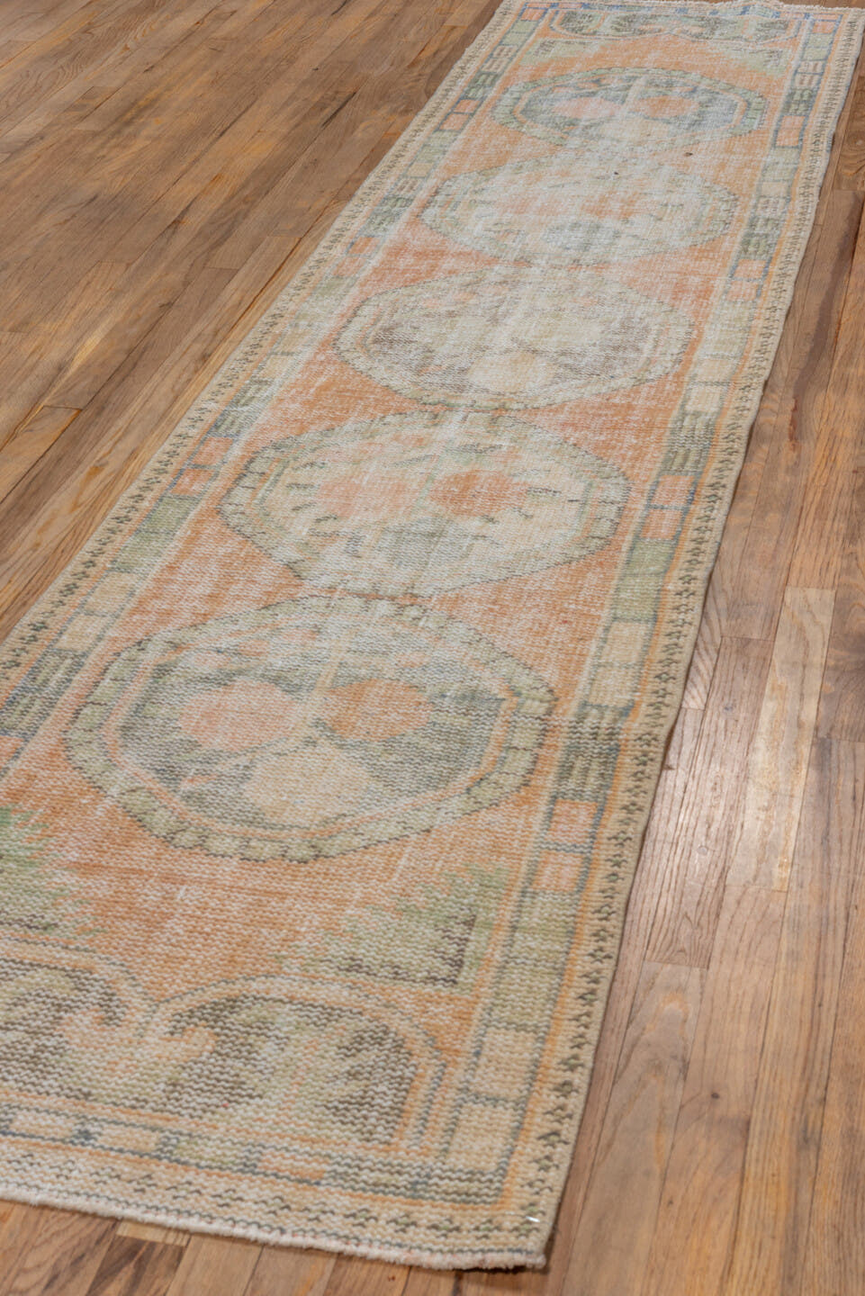 2' x 11' one-of-a-kind handmade vintage Oushak runner rug. Color palette: peach, sage, taupe, ivory, camel, gray, terracotta