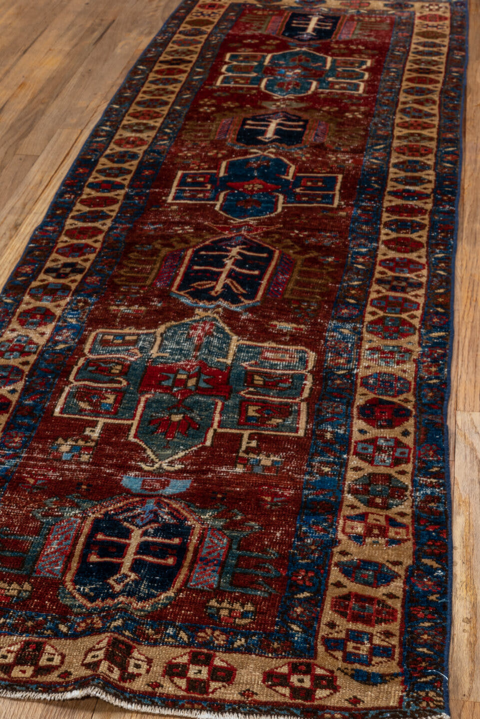 2' x 8' one-of-a-kind handmade vintage Heriz runner rug. Color palette: rust, ivory, navy, indigo, camel, taupe, burgundy