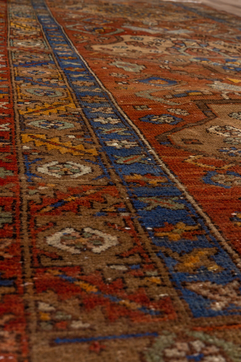 3' x 10' one-of-a-kind handmade vintage Heriz runner rug. Color palette: rust, camel, cobalt, ivory, gold, taupe, brown