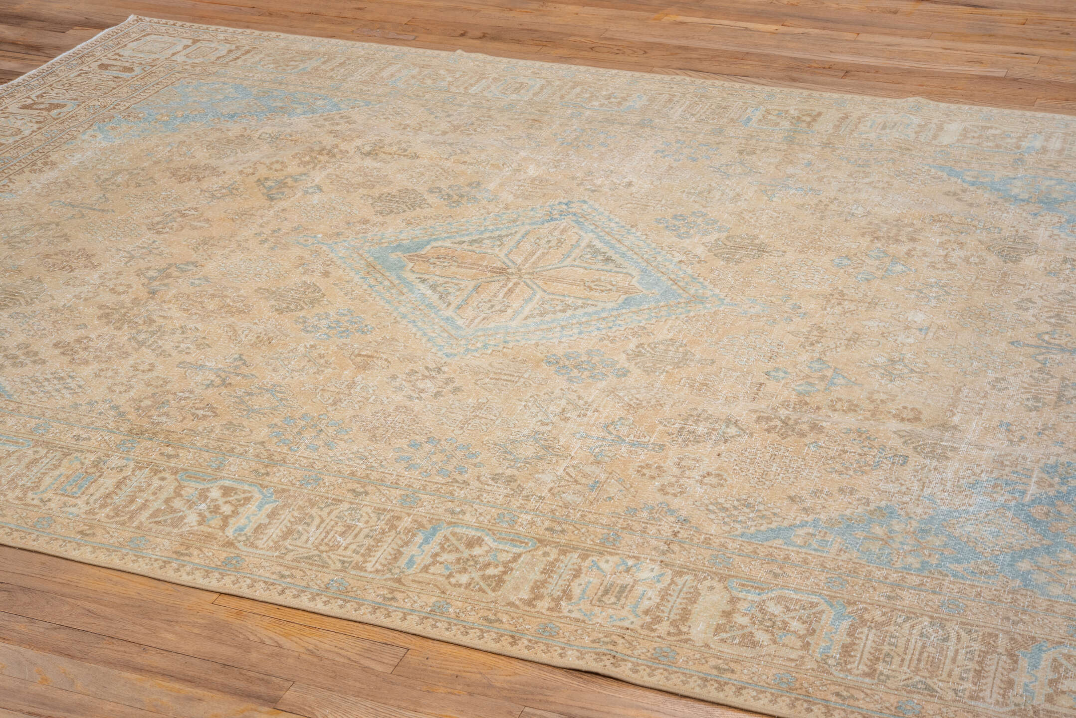 7' x 10' one-of-a-kind handmade vintage Joshegan large size rug. Color palette: camel, ivory, sky_blue, taupe, tan