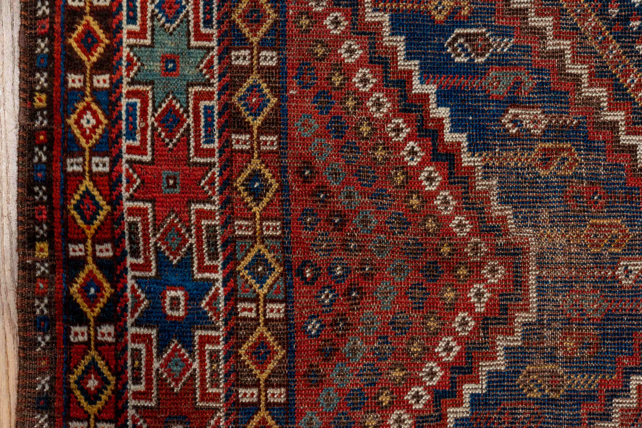 7' x 9' one-of-a-kind handmade vintage Shiraz rug. Color palette: rust, indigo, camel, ivory, crimson, navy, gold, brown