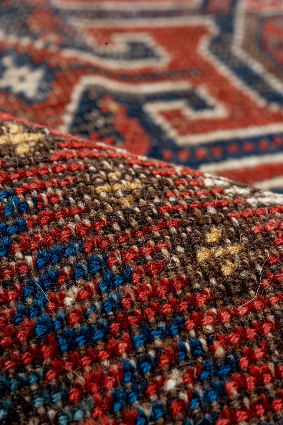 7' x 9' one-of-a-kind handmade vintage Shiraz rug. Color palette: rust, indigo, camel, ivory, crimson, navy, gold, brown
