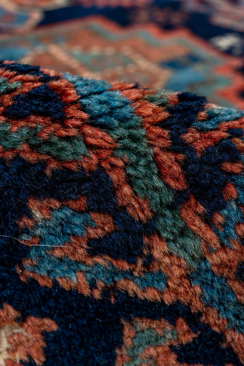 4' x 5' one-of-a-kind handmade vintage Kurd small size rug. Color palette: navy, turquoise, rust, ivory, coral, camel, blue