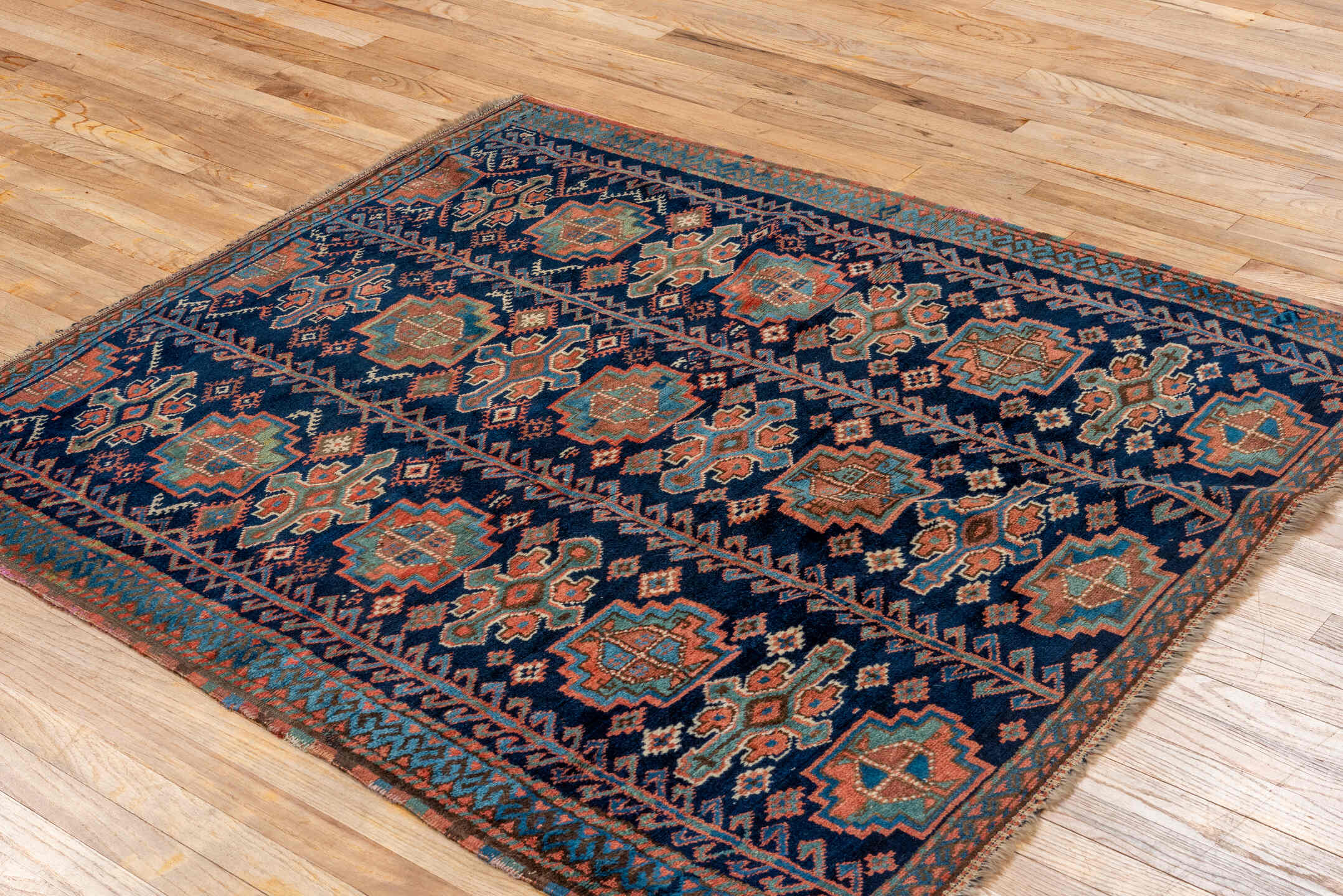 4' x 5' one-of-a-kind handmade vintage Kurd small size rug. Color palette: navy, turquoise, rust, ivory, coral, camel, blue