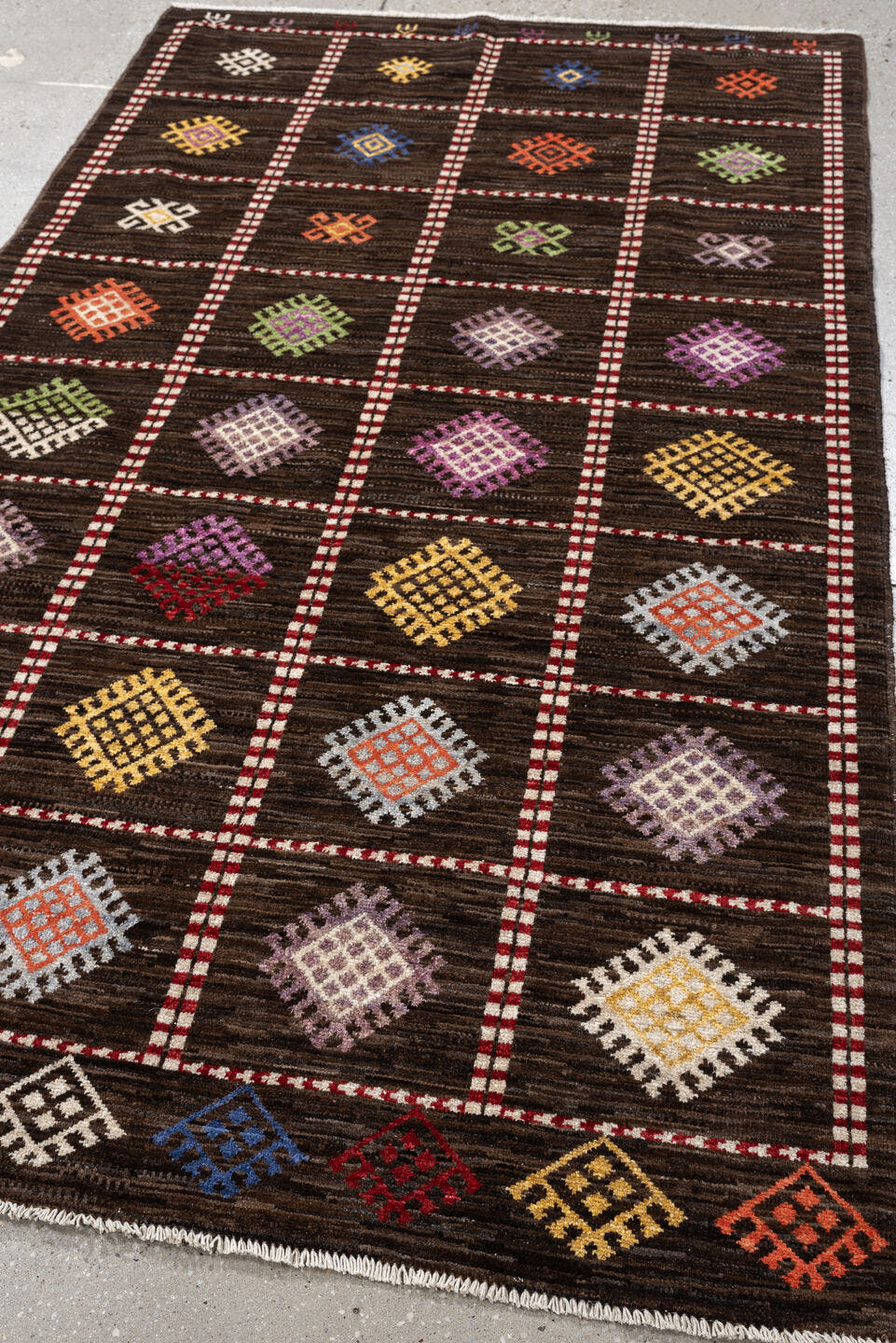 4' x 6' one-of-a-kind handmade vintage Jijim rug. Color palette: dark brown, ivory, coral, lavender, saffron, blue, sage