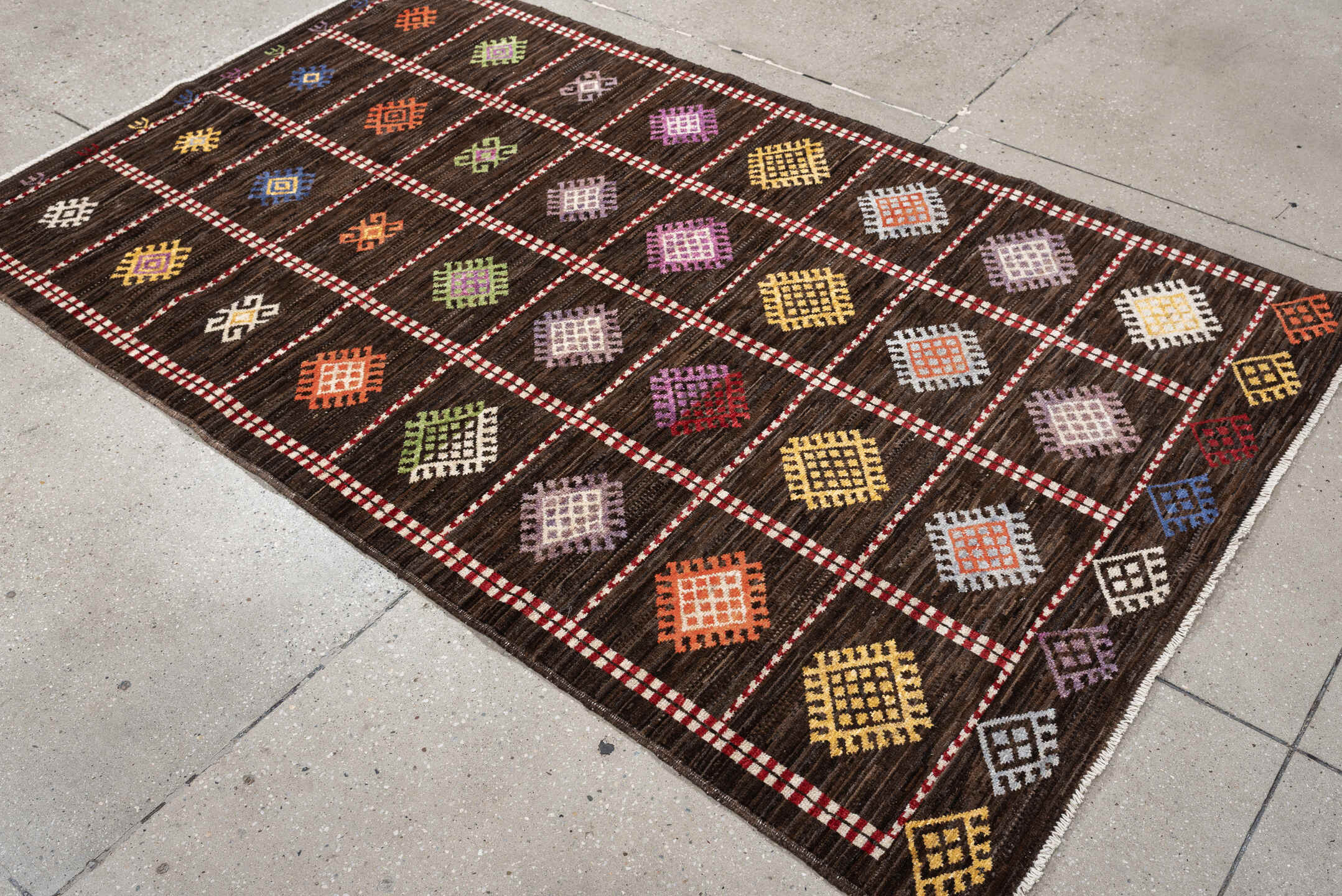 4' x 6' one-of-a-kind handmade vintage Jijim rug. Color palette: dark brown, ivory, coral, lavender, saffron, blue, sage