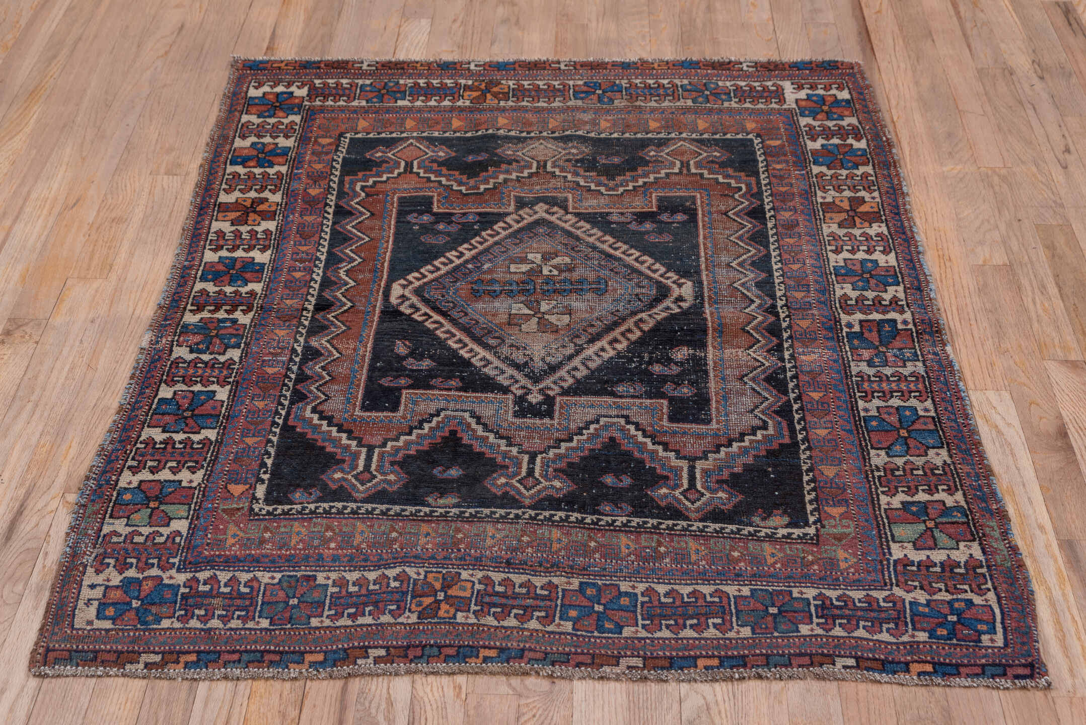 3' x 5' one-of-a-kind handmade antique Afshar small size rug. Color palette: indigo, rust, ivory, cobalt, camel, terracotta