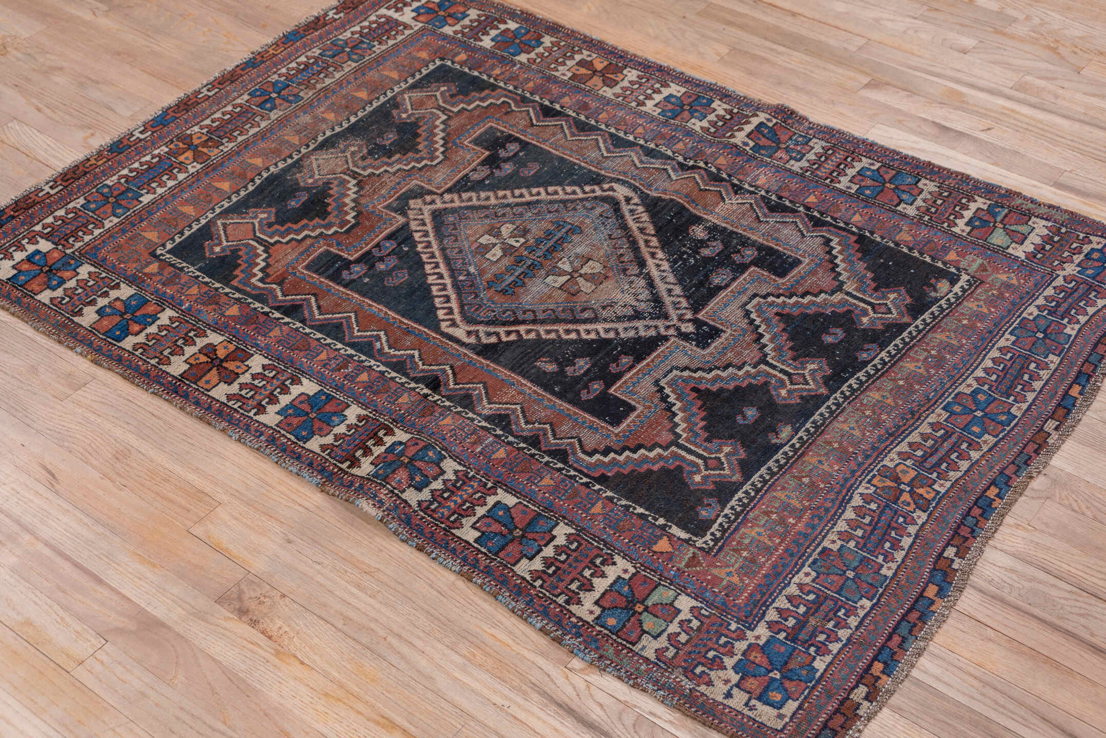 3' x 5' one-of-a-kind handmade antique Afshar small size rug. Color palette: indigo, rust, ivory, cobalt, camel, terracotta