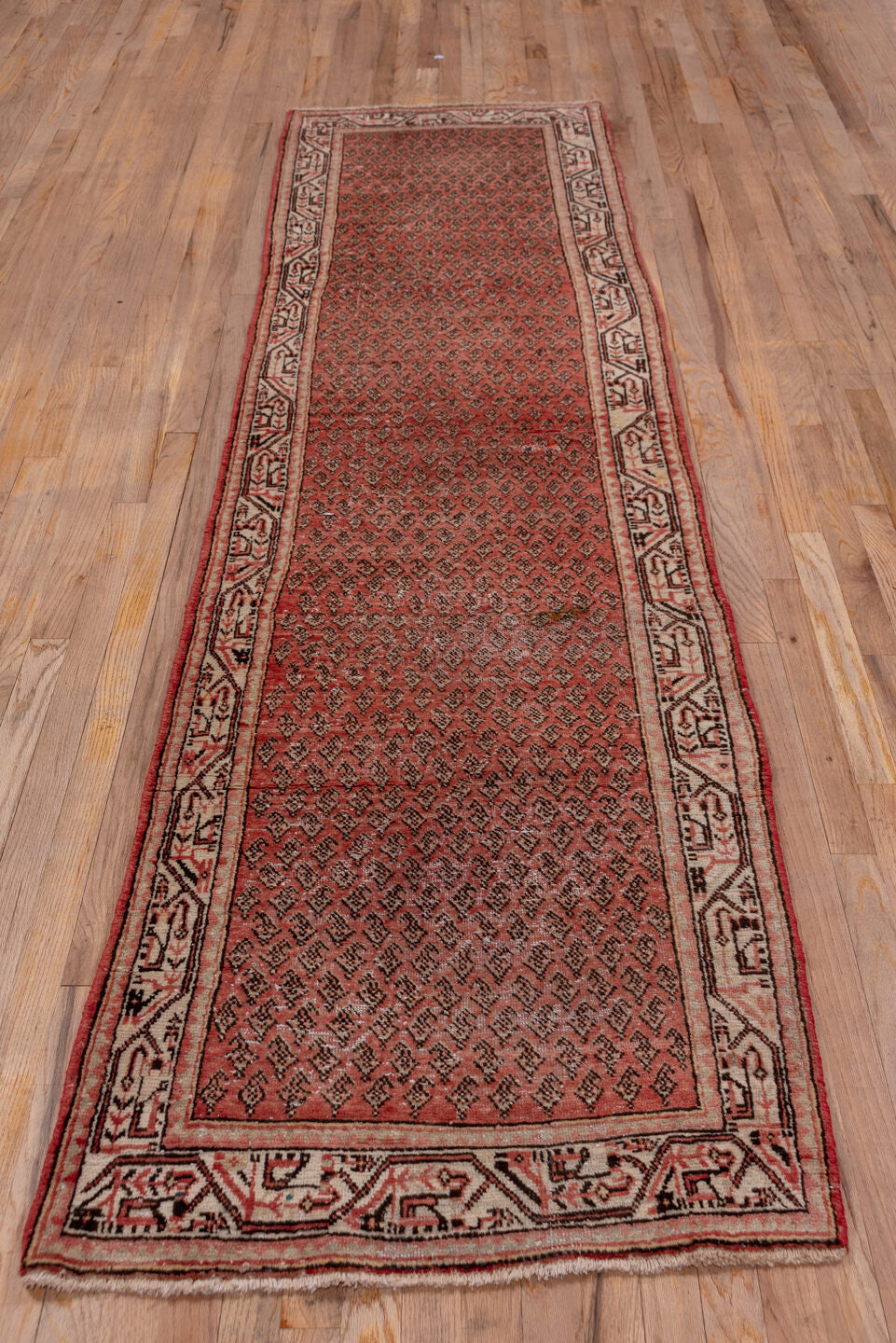 2' x 10' one-of-a-kind handmade vintage Mahal runner rug. Color palette: brown, gray, pink, red, redwood