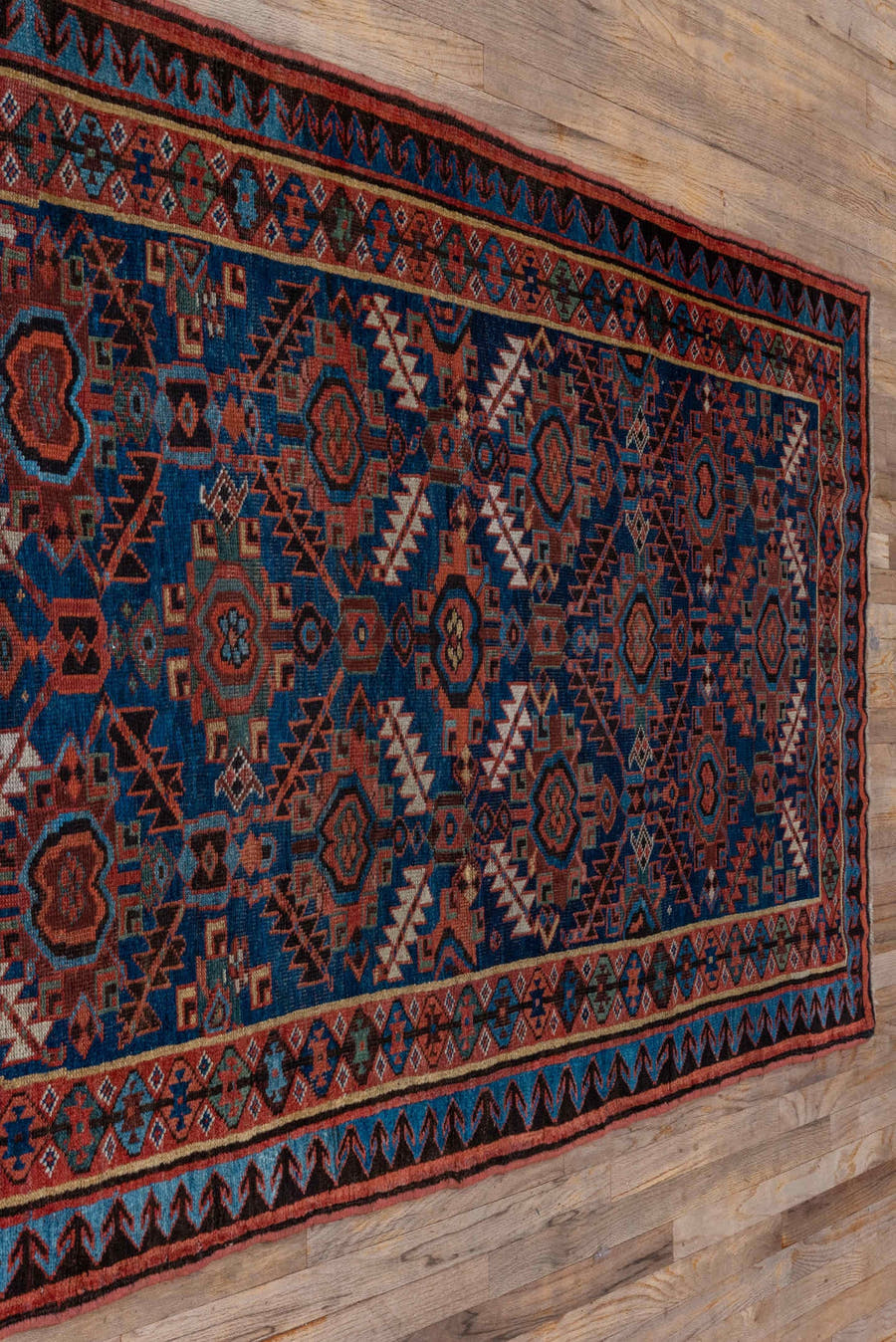 4' x 7' one-of-a-kind handmade antique NW Persian rug. Color palette: indigo, rust, ivory, crimson, slate, camel, charcoal