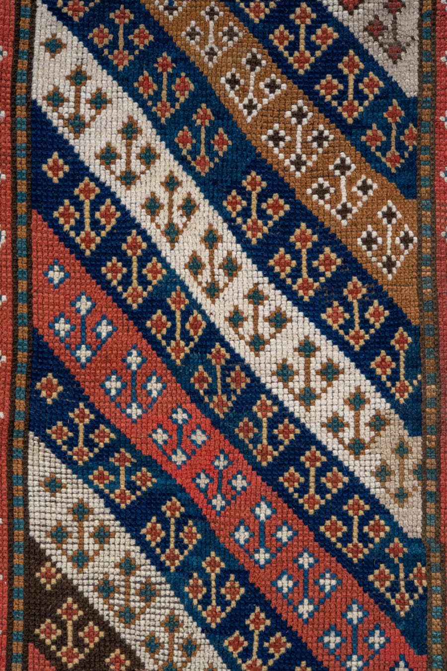 3' x 6' one-of-a-kind handmade antique Kazak small size rug. Color palette: ivory, navy, turquoise, rust, camel, terracotta