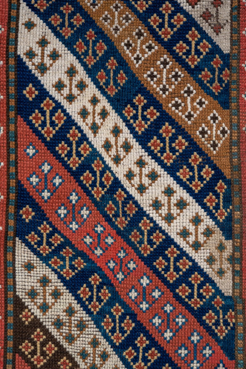 3' x 6' one-of-a-kind handmade antique Kazak small size rug. Color palette: ivory, navy, turquoise, rust, camel, terracotta