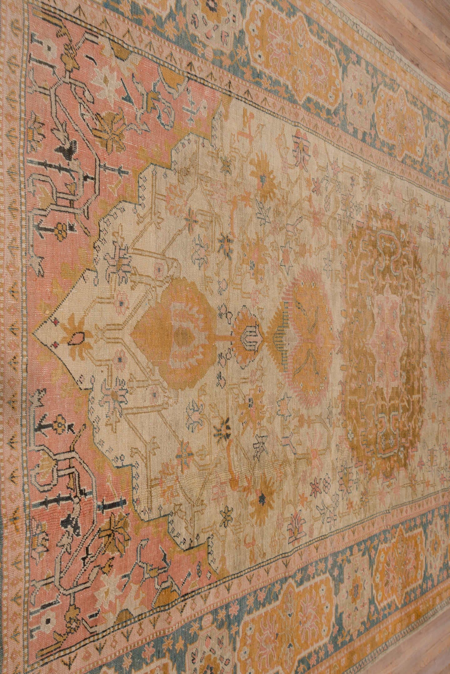 11' x 18' one-of-a-kind handmade antique Oushak oversize rug. Color palette: ivory, apricot, gold, sage, terra cotta, taupe