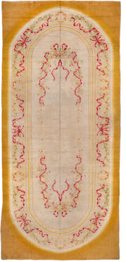 12' x 28' one-of-a-kind handmade antique Savonnerie oversize rug. Color palette: gold, ivory, rose, sage, cream, soft_green