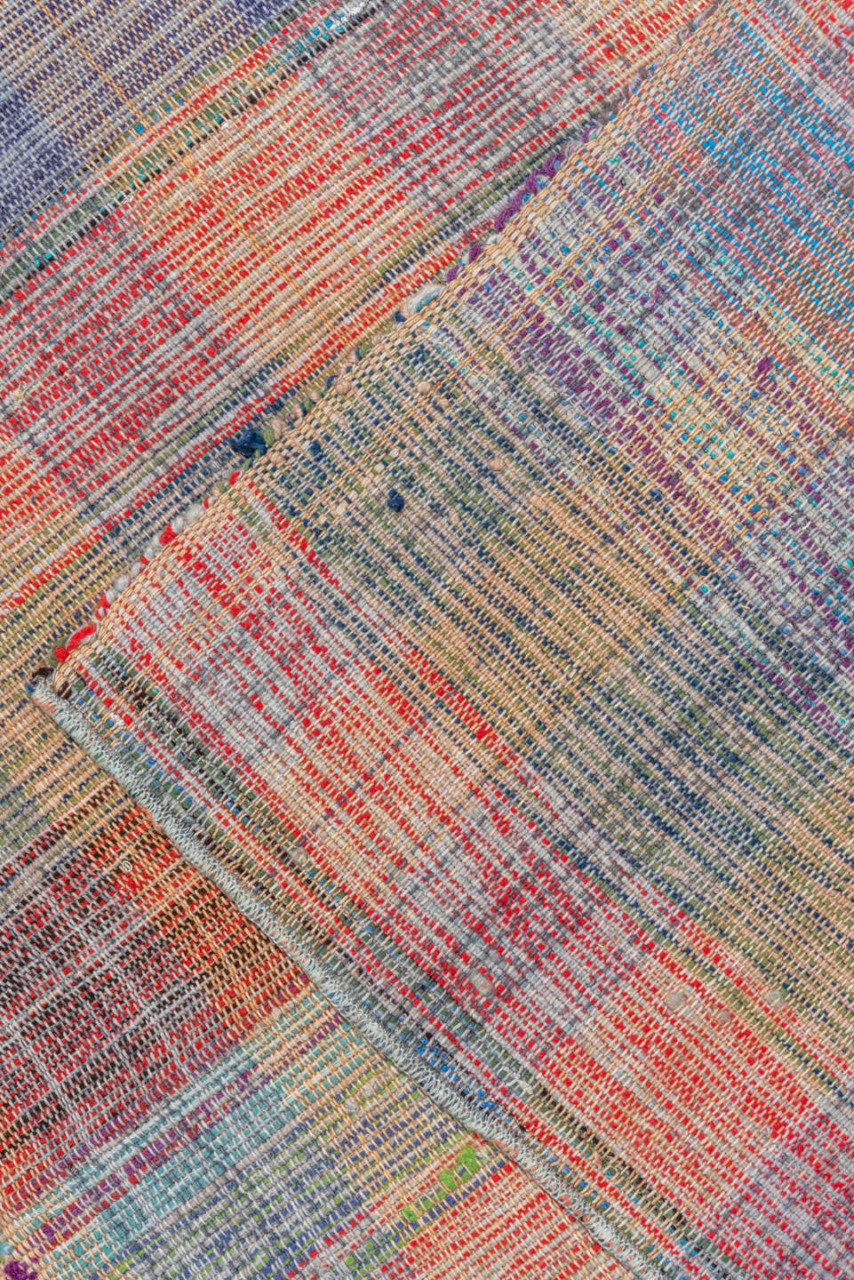 11' x 20' one-of-a-kind handmade vintage Rag Rug oversize rug. Color palette: blue, brown, dark gray, gray, pink, red