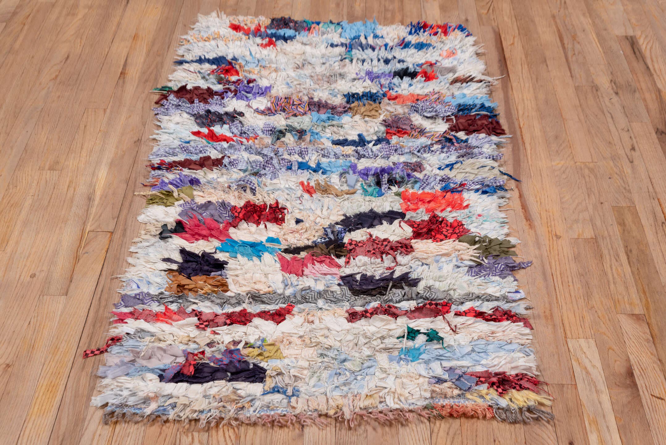 2' x 5' one-of-a-kind handmade vintage Rag Rug small size rug. Color palette: ivory, pale blue, navy, crimson, brown, violet
