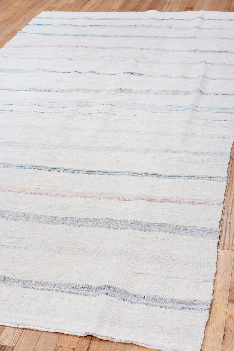 5' x 10' one-of-a-kind handmade vintage Rag Rug medium size rug. Color palette: ivory, pale blue, sky blue, charcoal, blush