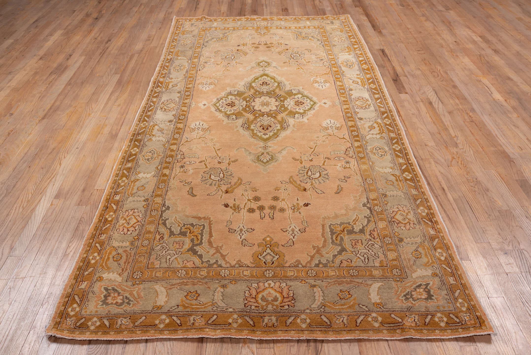 5' x 10' one-of-a-kind handmade antique Agra medium size rug. Color palette: peach, camel, ivory, taupe, gold, olive, brown