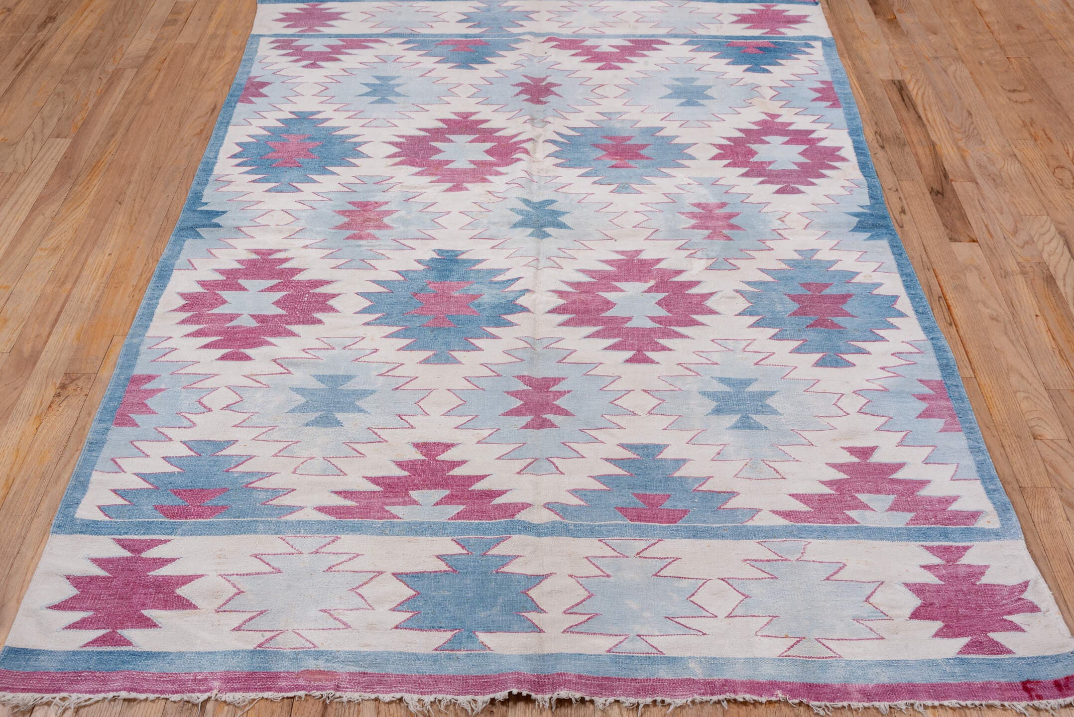 5' x 7' one-of-a-kind handmade antique Dhurrie rug. Color palette: ivory, sky blue, rose, dusty pink, light blue, pink, red