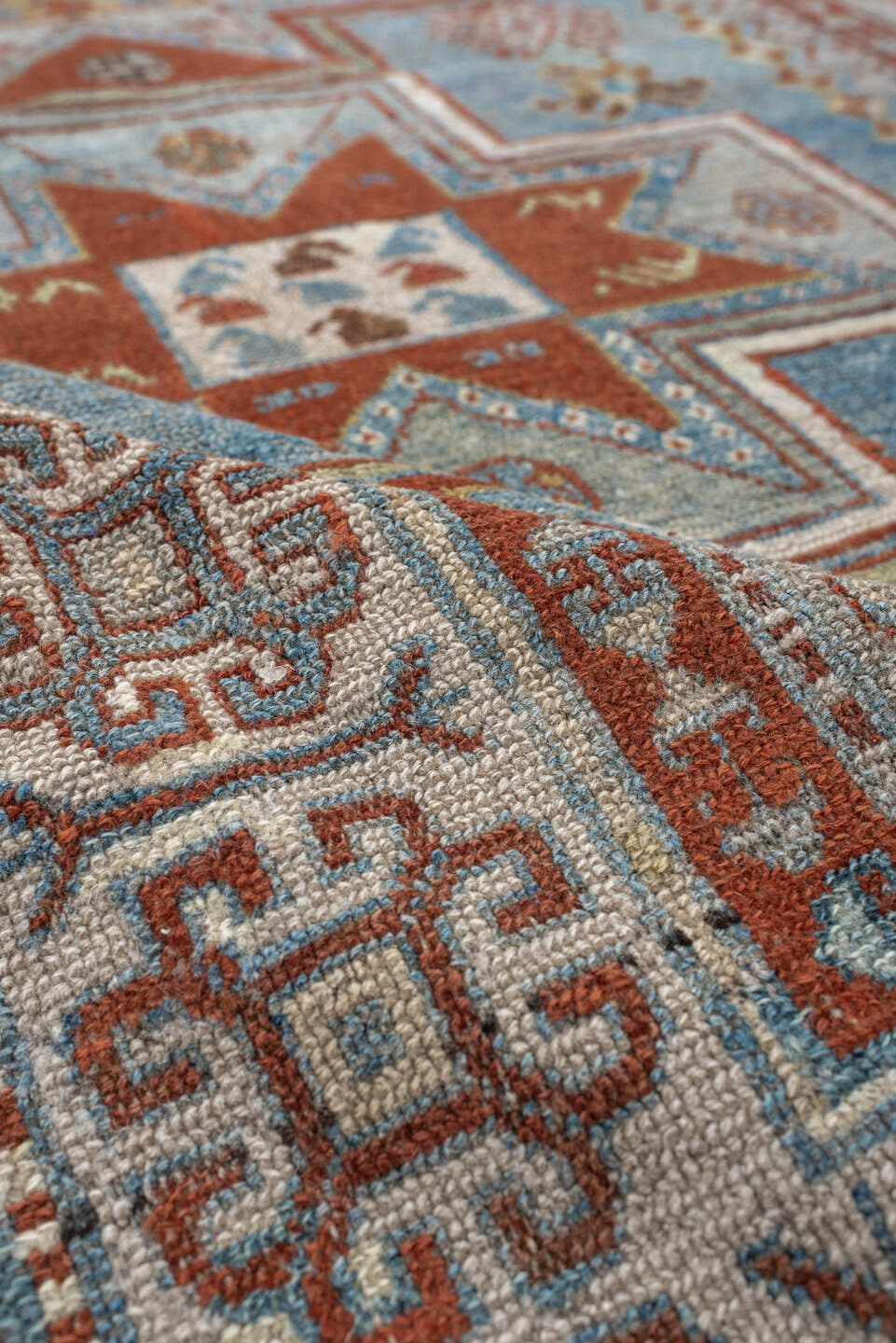3' x 4' one-of-a-kind handmade antique Caucasian small size rug. Color palette: ivory, sky blue, rust, terra cotta, camel
