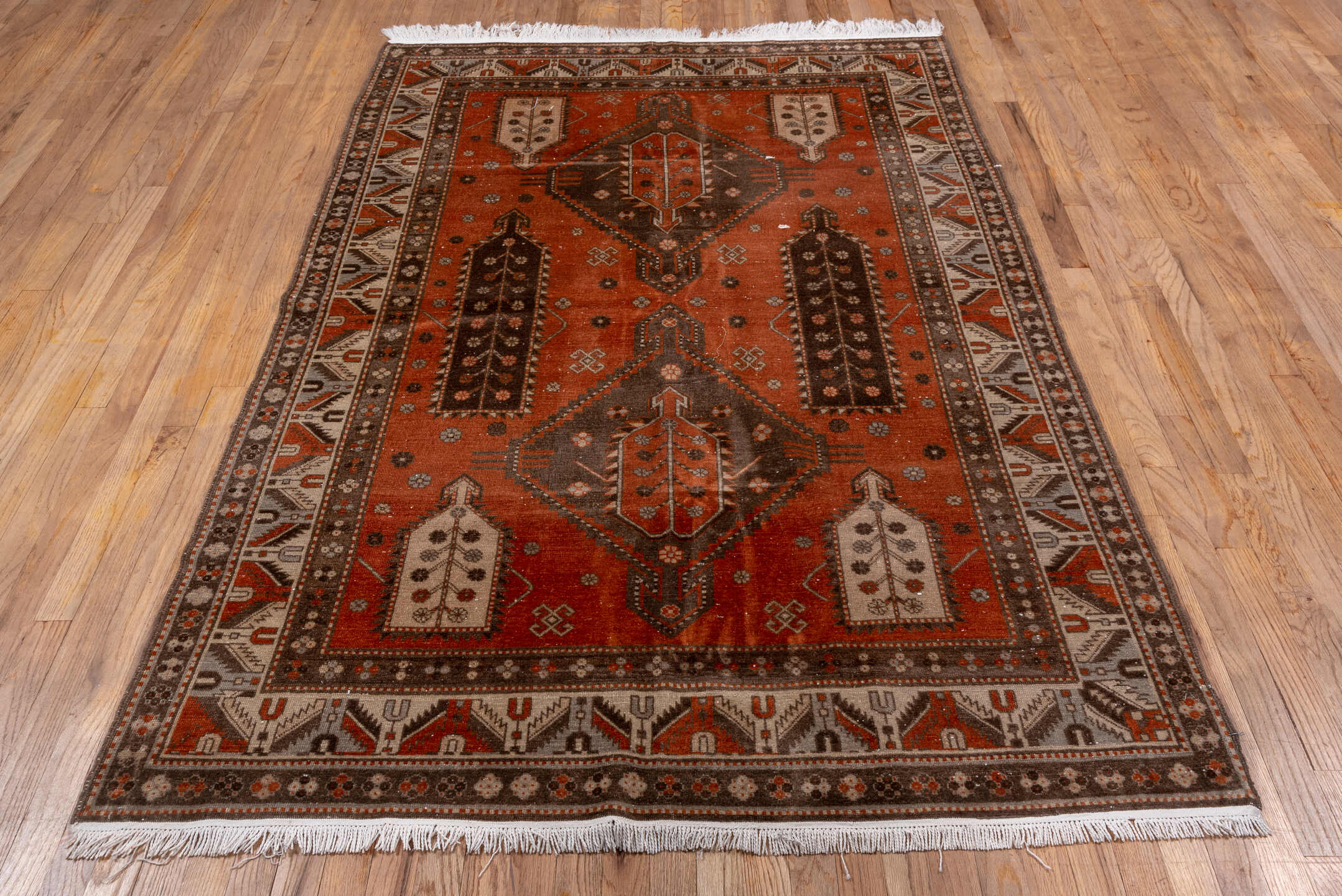 4' x 7' one-of-a-kind handmade vintage Caucasian rug. Color palette: terra cotta, ivory, brown, rust, taupe, charcoal, camel