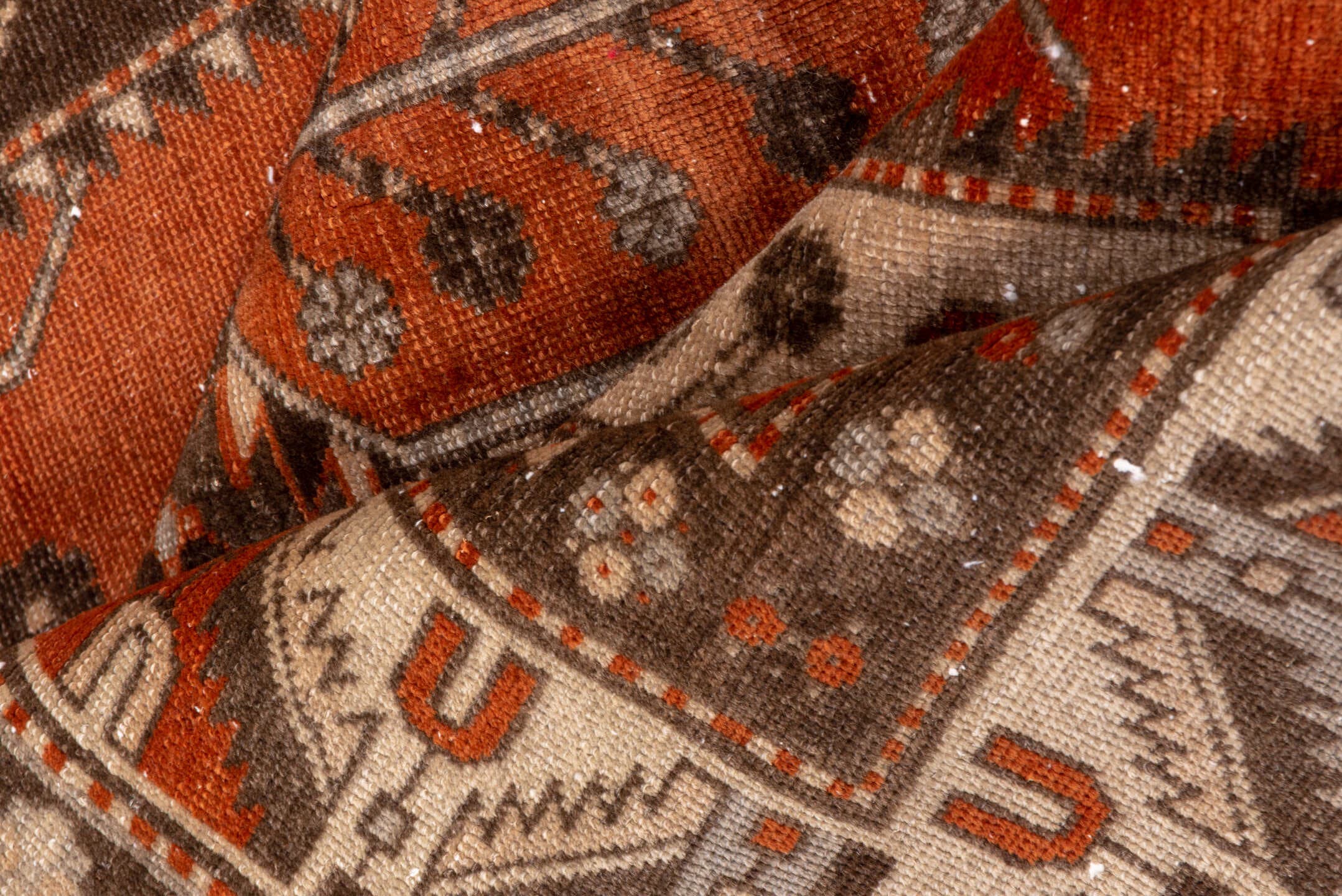 4' x 7' one-of-a-kind handmade vintage Caucasian rug. Color palette: terra cotta, ivory, brown, rust, taupe, charcoal, camel