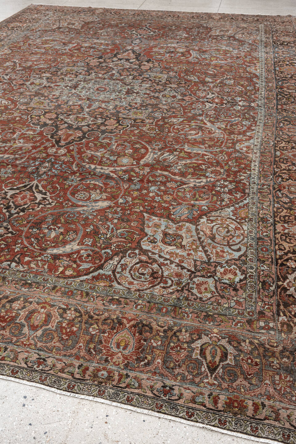 10' x 15' one-of-a-kind handmade antique Baktiary oversize rug. Color palette: terracotta, ivory, charcoal, sky blue, taupe
