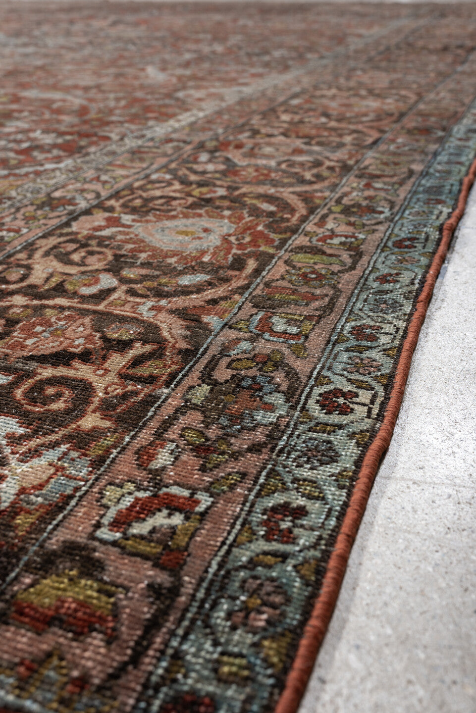 10' x 15' one-of-a-kind handmade antique Baktiary oversize rug. Color palette: terracotta, ivory, charcoal, sky blue, taupe