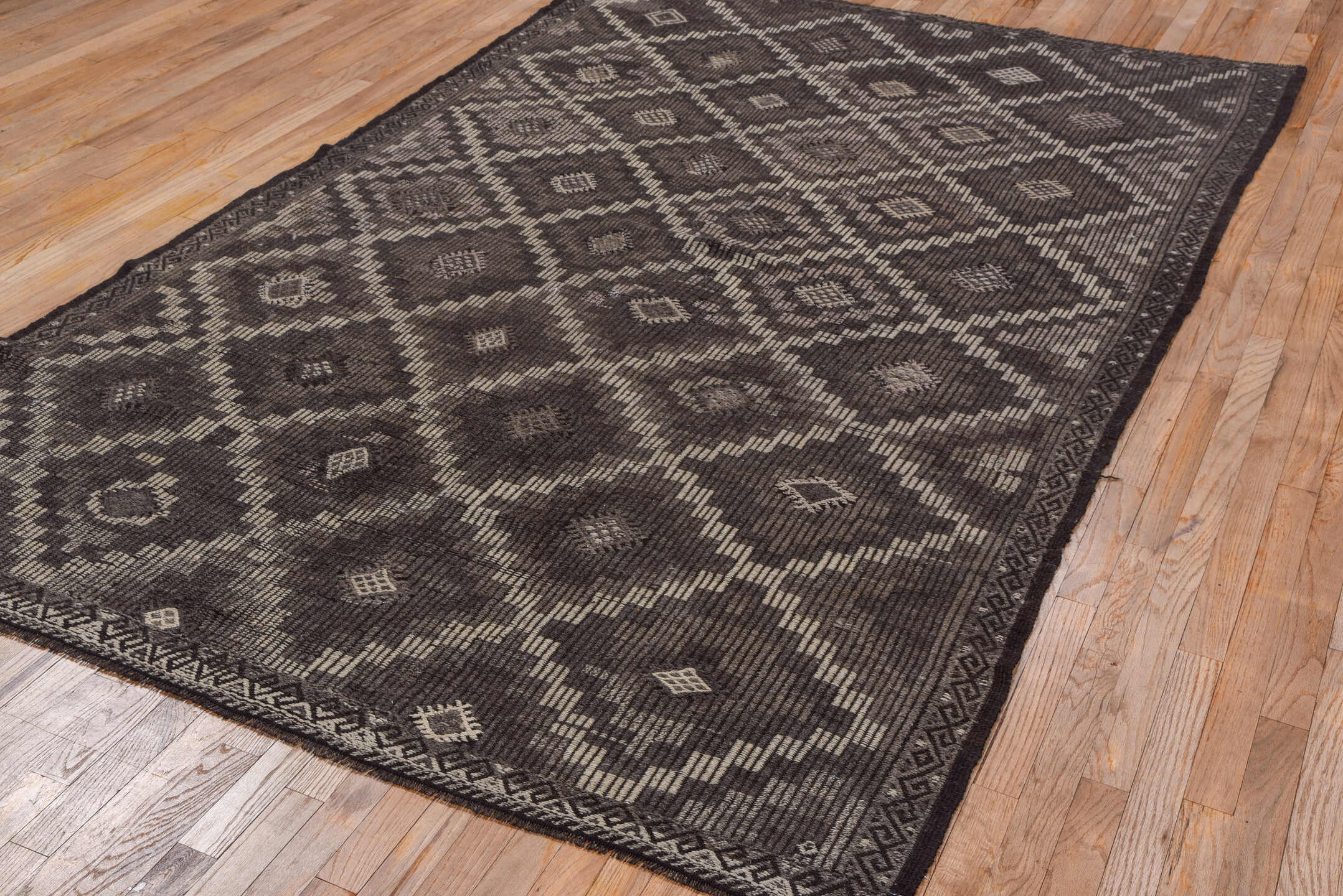 6' x 9' one-of-a-kind handmade vintage Jijim medium size rug. Color palette: charcoal, taupe, brown, ivory, mauve, gray